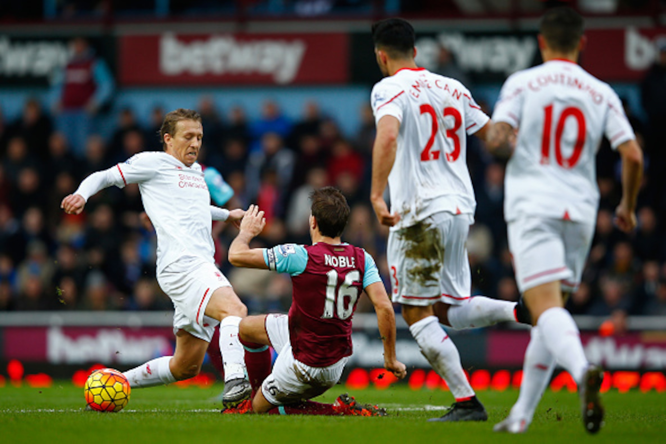 LONDON, ENGLAND - JANUARY 02: Lucas Leiva of Liverpool fouls Mark Noble of West Ham United resulting in the yellow card during the Barclays Premier League match between West Ham United and Liverpool at Boleyn Ground on January 2, 2016 in London, England. 
