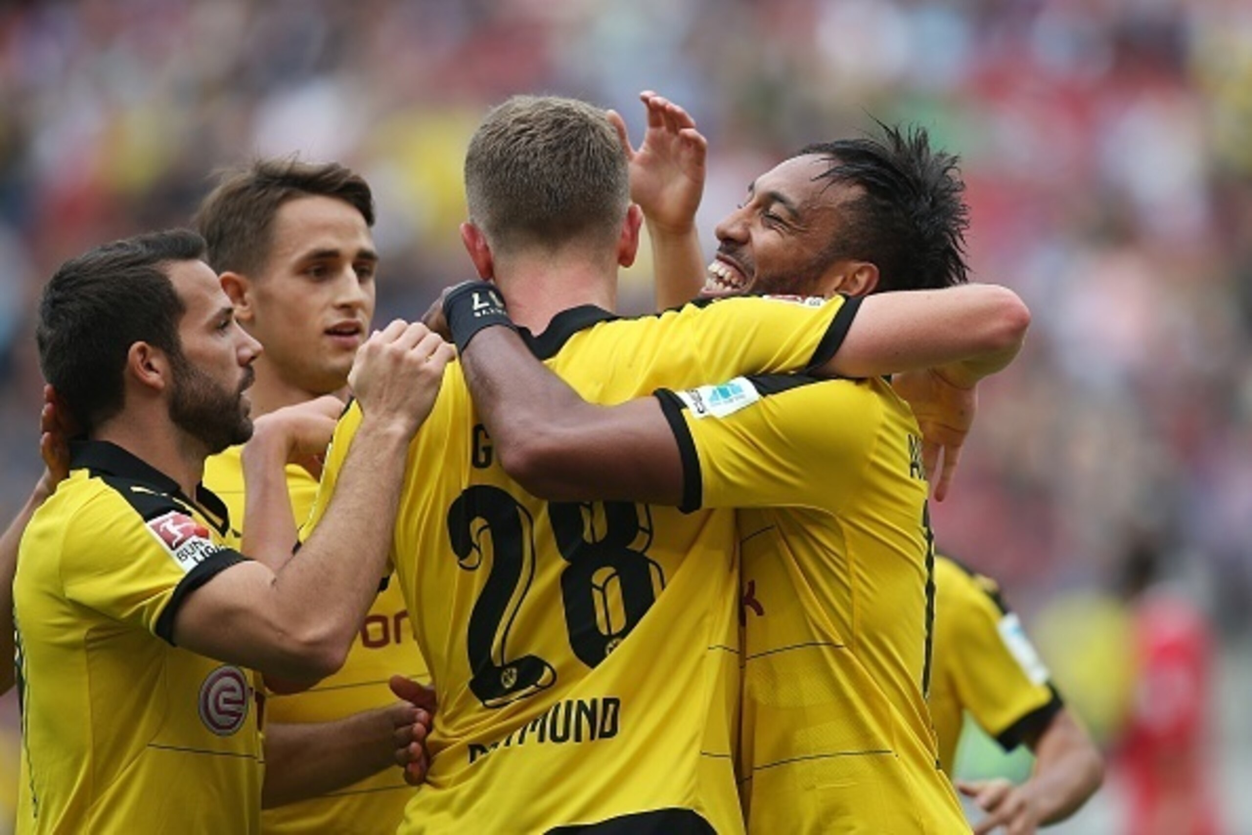 (L-R) Dortmund's midfielder Gonzalo Castro, Belgian midfielder Adnan Januzaj, defender Matthias Ginter and Gabonese striker Pierre-Emerick Aubameyang celebrate their team's fourth goal during the German first division Bundesliga football match Hannover 96