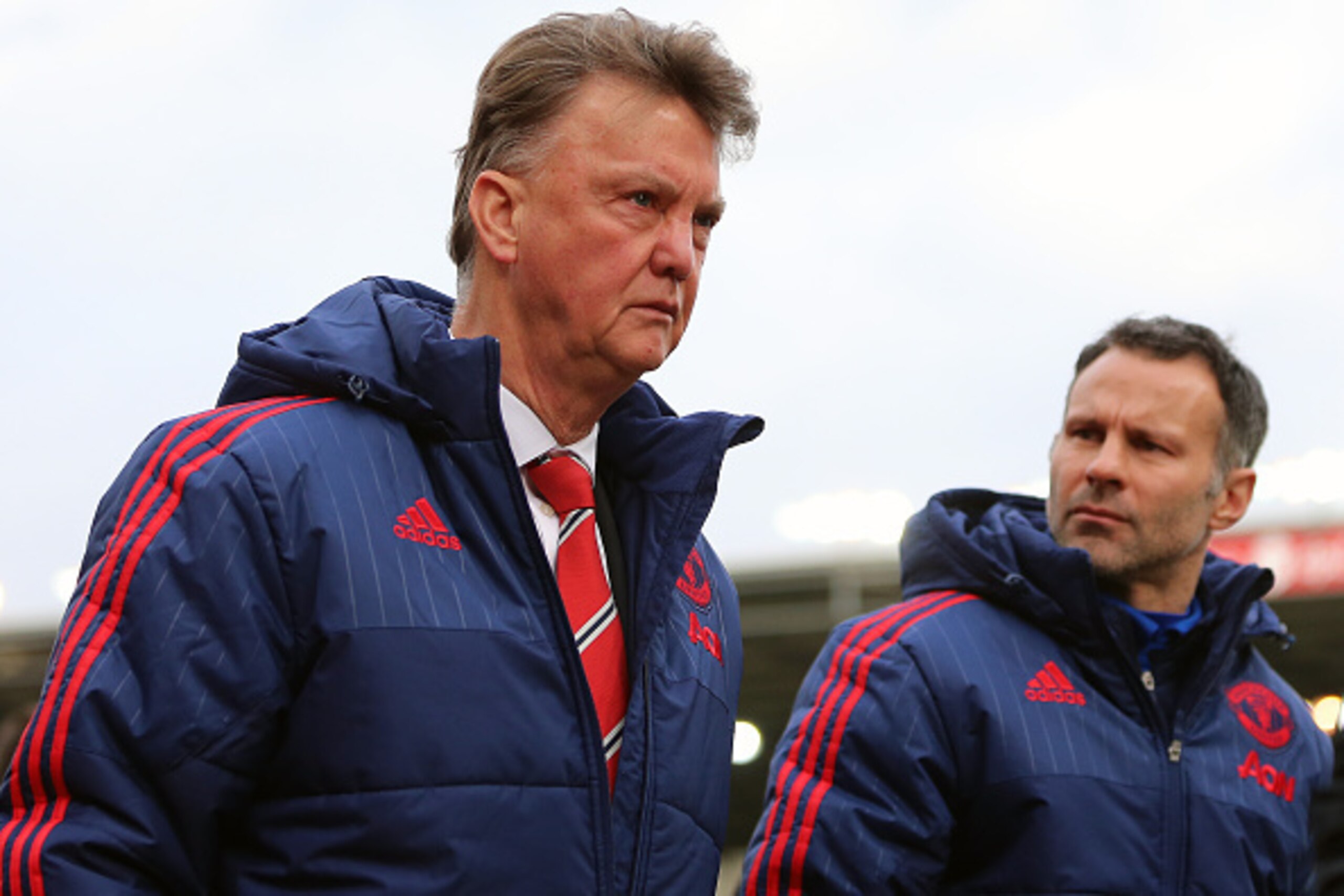 STOKE ON TRENT, ENGLAND - DECEMBER 26: Louis van Gaal the head coach / manager of Manchester United and Ryan Giggs the assistant head coach / assistant manager of Manchester United looks on during the Barclays Premier League match between Stoke City and M