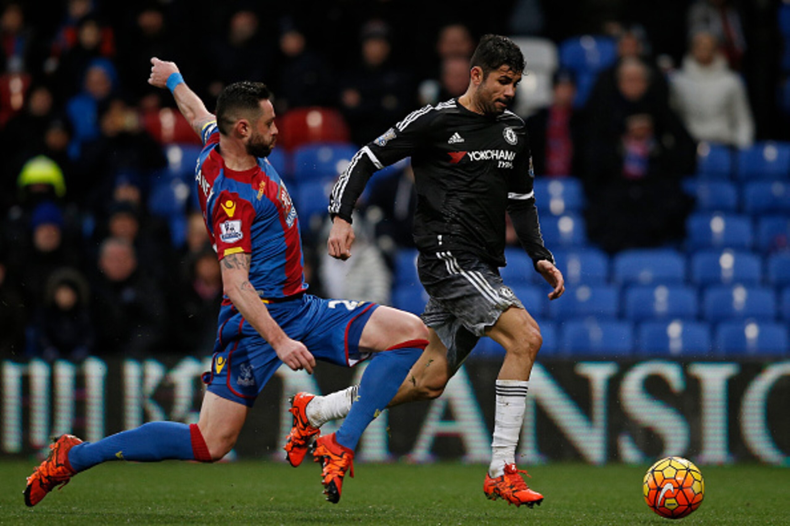 Crystal Palace's Irish defender Damien Delaney (L) jumps to clear the ball from the path of Chelsea's Brazilian-born Spanish striker Diego Costa as he makes a run on goal during the English Premier League football match between Crystal Palace and Chelsea 