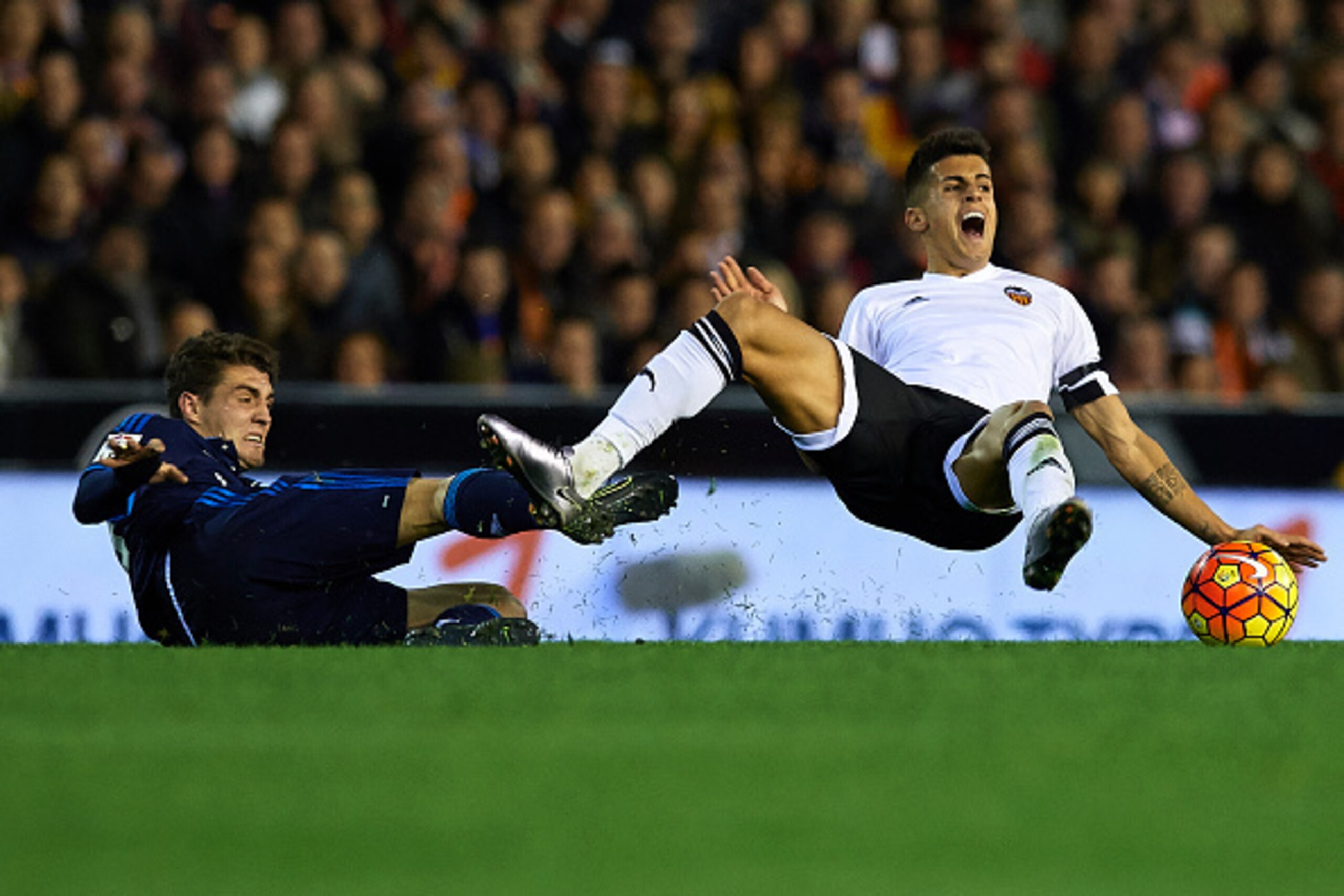 VALENCIA, SPAIN - JANUARY 03: Joao Cancelo (R) of Valencia is tackled by Mateo Kovacic of Real Madrid during the La Liga match between Valencia CF and Real Madrid CF at Estadi de Mestalla on January 03, 2016 in Valencia, Spain. (Photo by Manuel Queimade VALENCIA, SPAIN - JANUARY 03: Joao Cancelo (R) of Valencia is tackled by Mateo Kovacic of Real Madrid during the La Liga match between Valencia CF and Real Madrid CF at Estadi de Mestalla on January 03, 2016 in Valencia, Spain. (Photo by Manuel Queimade