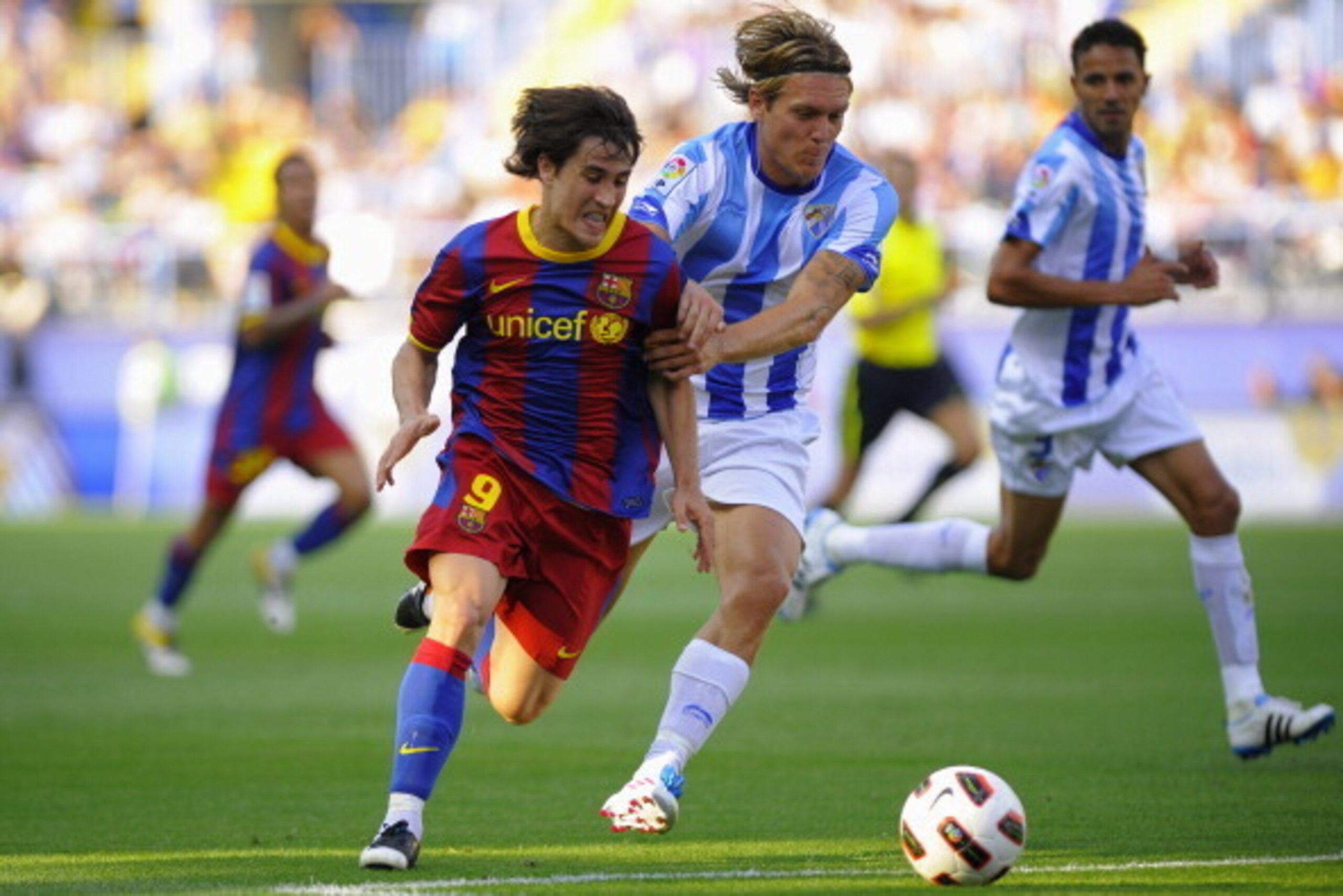Barcelona's forward Bojan Krkic (L) vies with Malaga's Danish defender Kris Stadsgaard (R) during the Spanish league football match Malaga vs Barcelona on May 21, 2011 at the Rosaleda stadium in Malaga. AFP PHOTO / JORGE GUERRERO (Photo credit should read