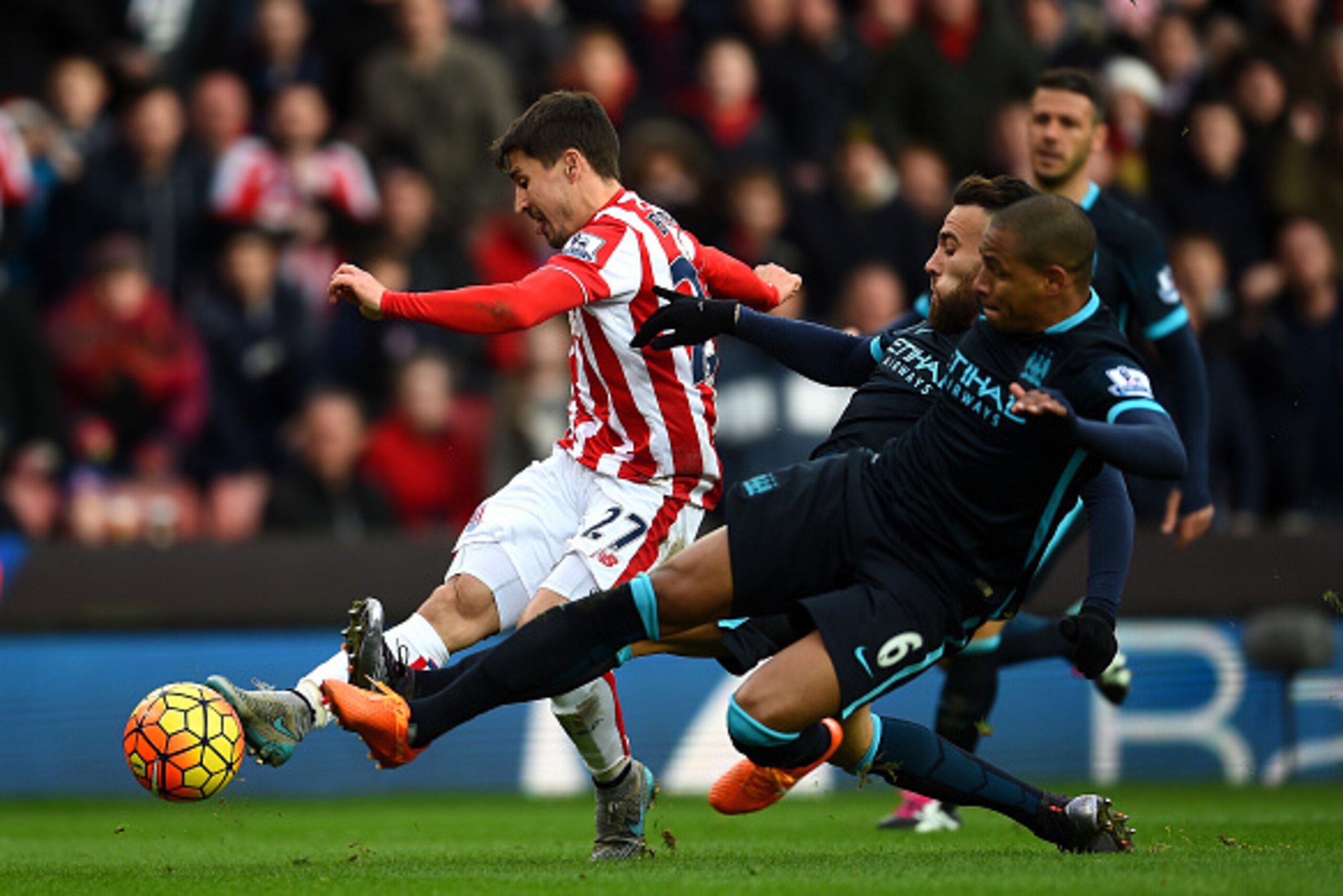 STOKE ON TRENT, ENGLAND - DECEMBER 05: Bojan Krkic (L) of Stoke City shoots at goal while Nicolas Otamendi (C) and Fernando (R) of Manchester City try to block during the Barclays Premier League match between Stoke City and Manchester City at Britannia St