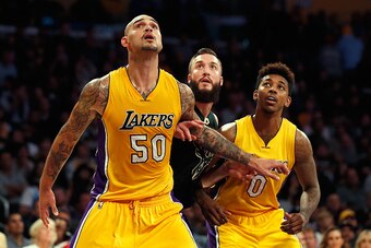 LOS ANGELES, CA - DECEMBER 15:  Robert Sacre #50 of the Los Angeles Lakers and Nick Young #0 of the Los Angeles Lakers box out Miles Plumlee #18 of the Milwaukee Bucks during a game at Staples Center on December 15, 2015 in Los Angeles, California.  NOTE 
