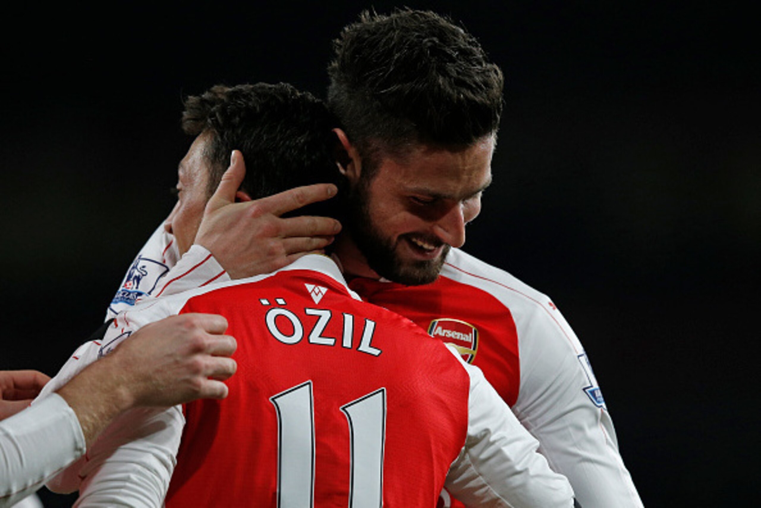 Arsenal's German midfielder Mesut Ozil celebrates with Arsenal's French striker Olivier Giroud (R) after scoring their second goal during the English Premier League football match between Arsenal and Bournemouth at the Emirates Stadium in London on Decemb