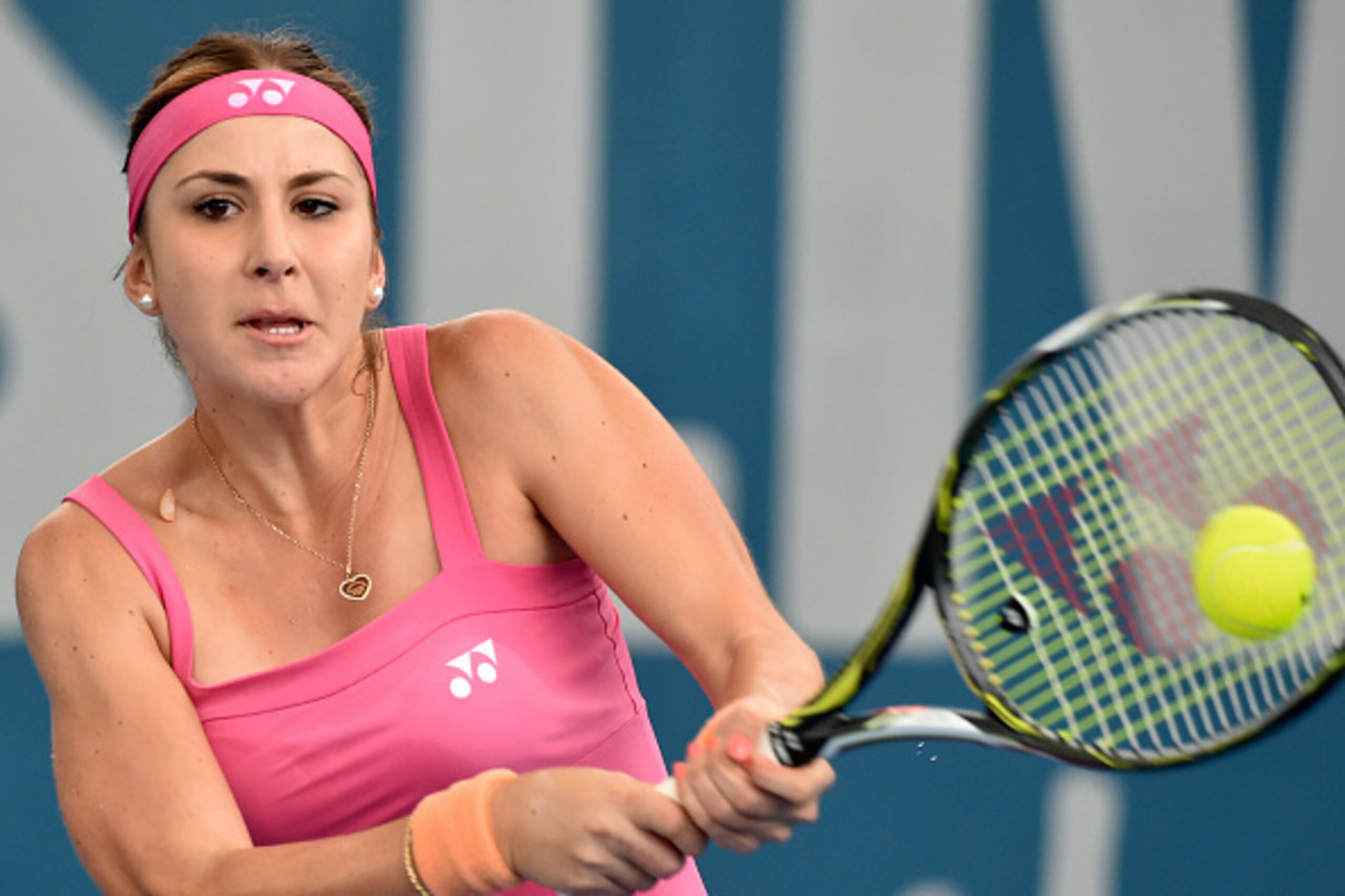 Switzerland's Belinda Bencic hits a return against Sara Errani of Italy in their women's singles match on the second day at the Brisbane International tennis tournament on January 4, 2016.    AFP PHOTO / Saeed KHAN
-- IMAGE RESTRICTED TO EDITORIAL USE - S
