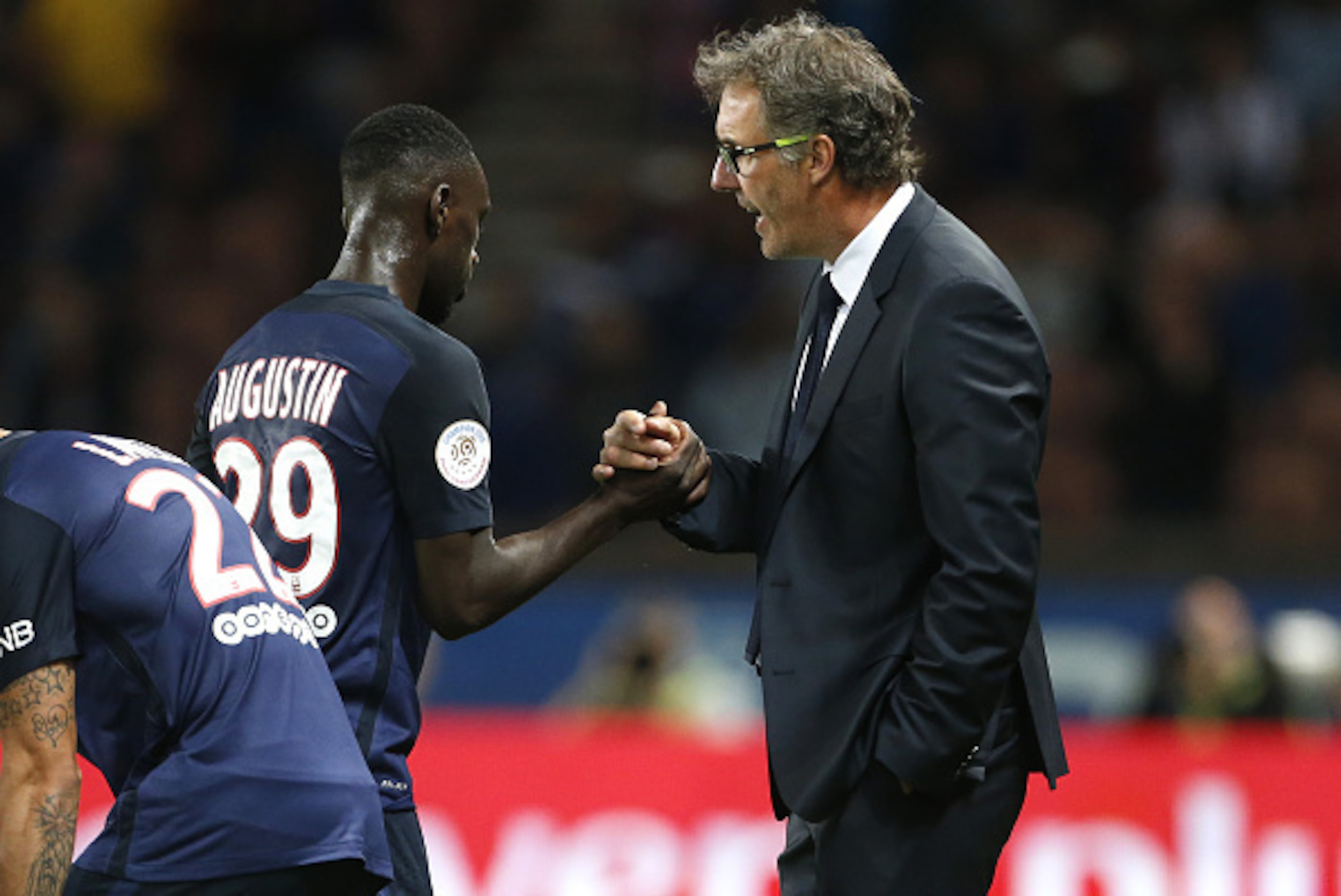 PARIS - AUGUST 16: Head coach of PSG Laurent Blanc greets Jean-Kevin Augustin of PSG during the French Ligue 1 match between Paris Saint-Germain FC (PSG) and GFC Ajaccio (Gazelec Ajaccio) at Parc des Princes stadium on August 16, 2015 in Paris, France. (P
