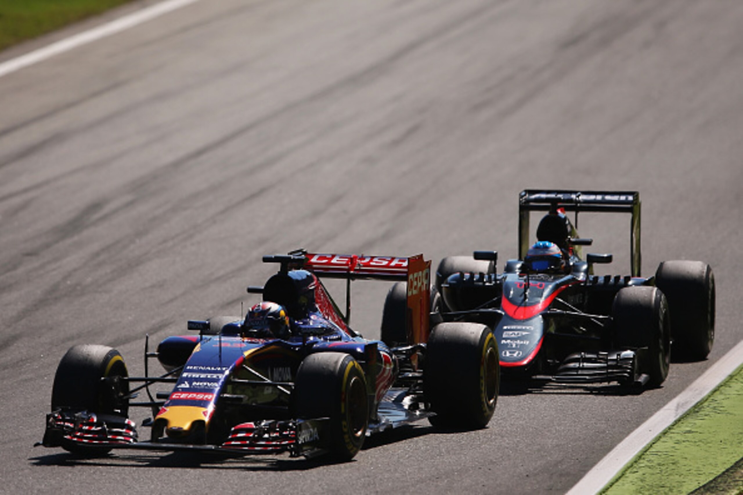 MONZA, ITALY - SEPTEMBER 06:  Max Verstappen of Netherlands and Scuderia Toro Rosso drives ahead of Fernando Alonso of Spain and McLaren Honda during the Formula One Grand Prix of Italy at Autodromo di Monza on September 6, 2015 in Monza, Italy.  (Photo b