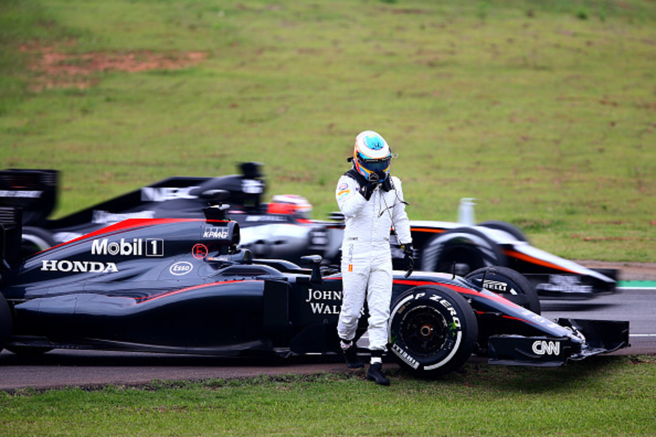 SAO PAULO, BRAZIL - NOVEMBER 13:  Fernando Alonso of Spain and McLaren Honda walks away from his car after he stopped on track during practice for the Formula One Grand Prix of Brazil at Autodromo Jose Carlos Pace on November 13, 2015 in Sao Paulo, Brazil