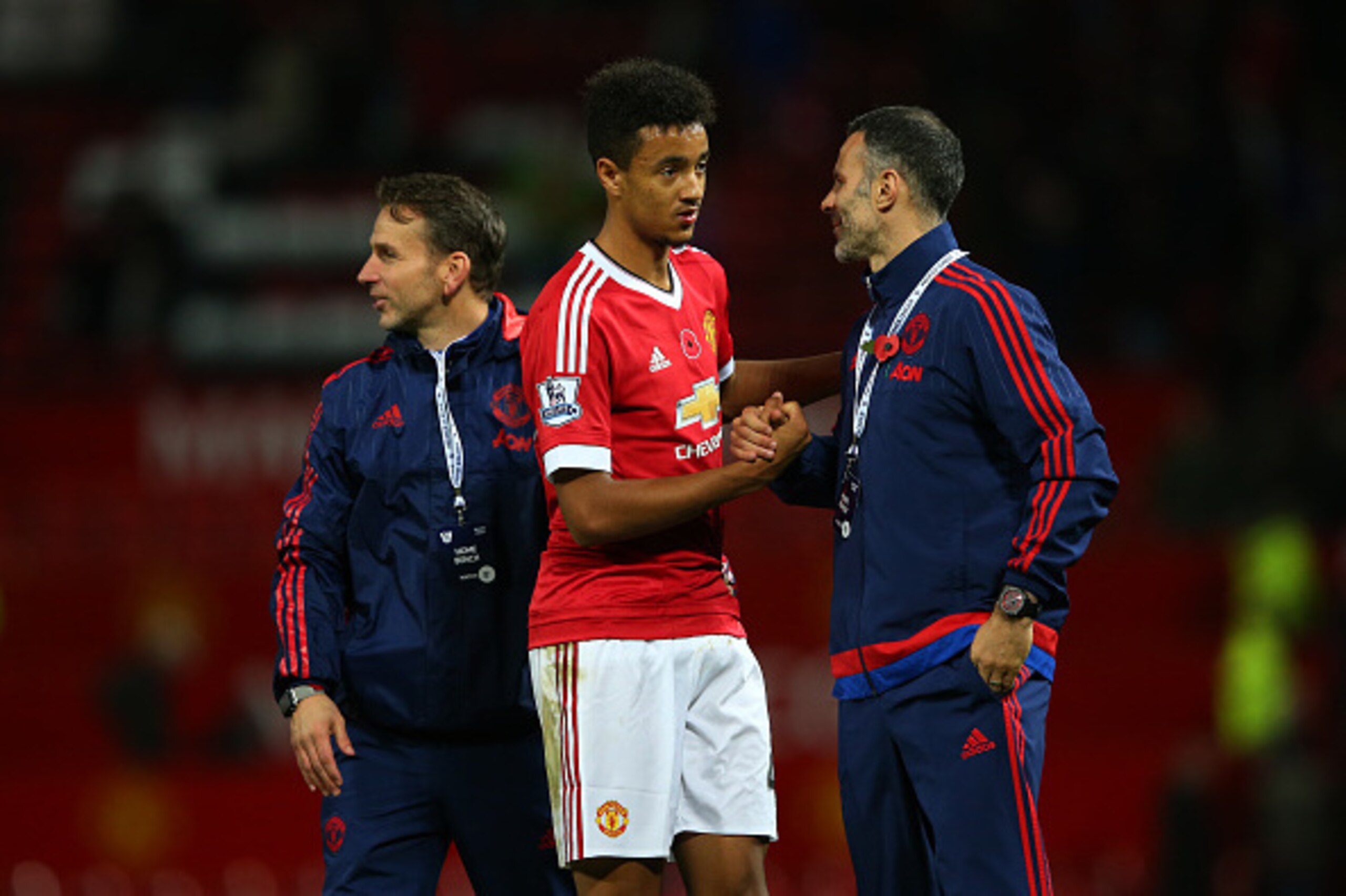 MANCHESTER, ENGLAND - NOVEMBER 07: Cameron Borthwick-Jackson (C) shakes hands with assistant manager Ryan Giggs (R) after their team's 2-0 win in  the Barclays Premier League match between Manchester United and West Bromwich Albion at Old Trafford on Nove