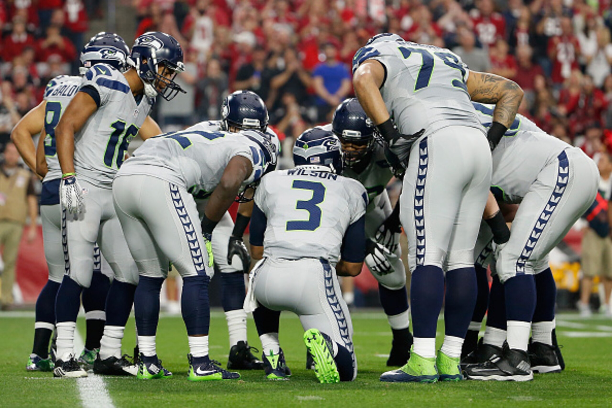 GLENDALE, AZ - JANUARY 03: Quarterback Russell Wilson #3 of the Seattle Seahawks talks with his team in a huddle during the NFL game against the Arizona Cardinals at the University of Phoenix Stadium on January 3, 2016 in Glendale, Arizona. (Photo by Chri