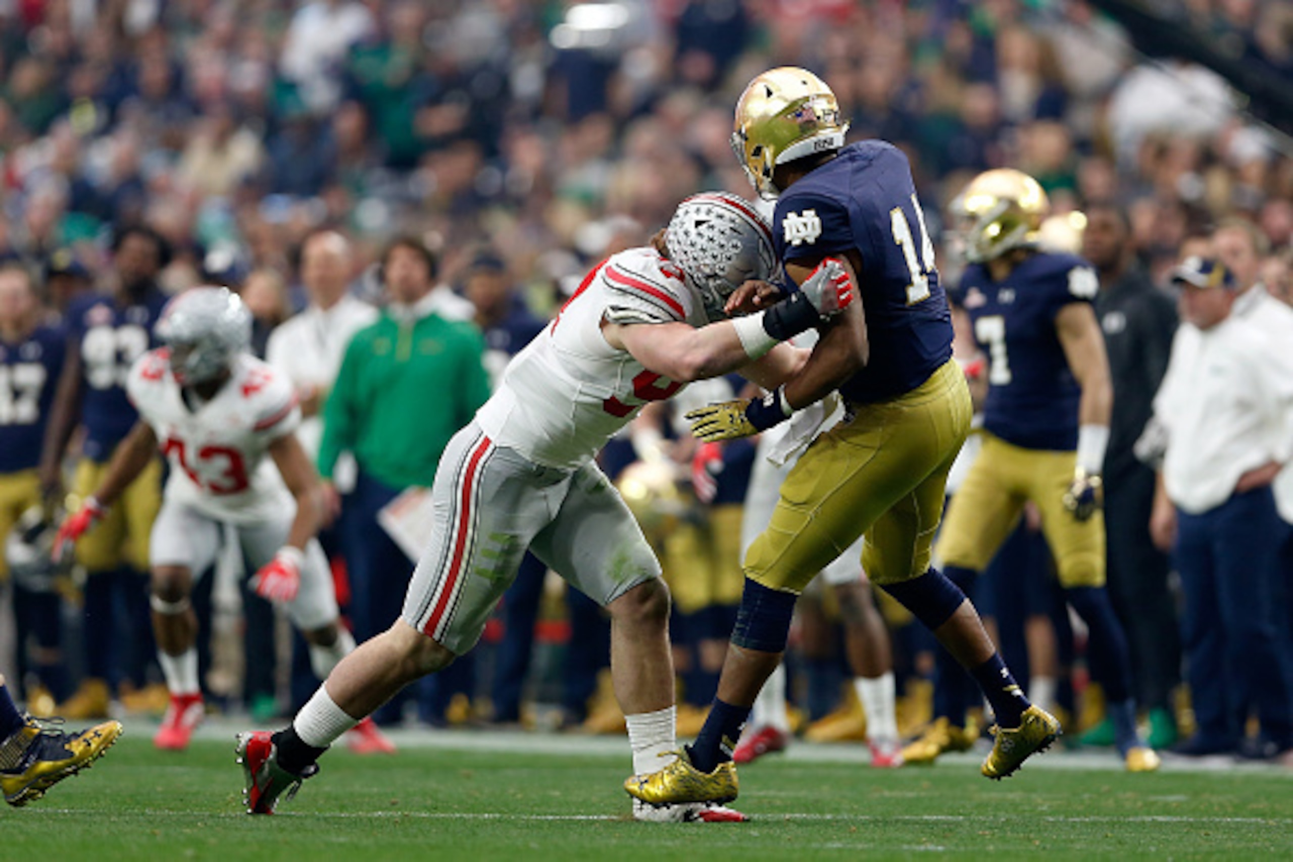 GLENDALE, AZ - JANUARY 01:  Defensive lineman Joey Bosa #97 of the Ohio State Buckeyes hits quarterback DeShone Kizer #14 of the Notre Dame Fighting Irish during the first quarter of the BattleFrog Fiesta Bowl at University of Phoenix Stadium on January 1