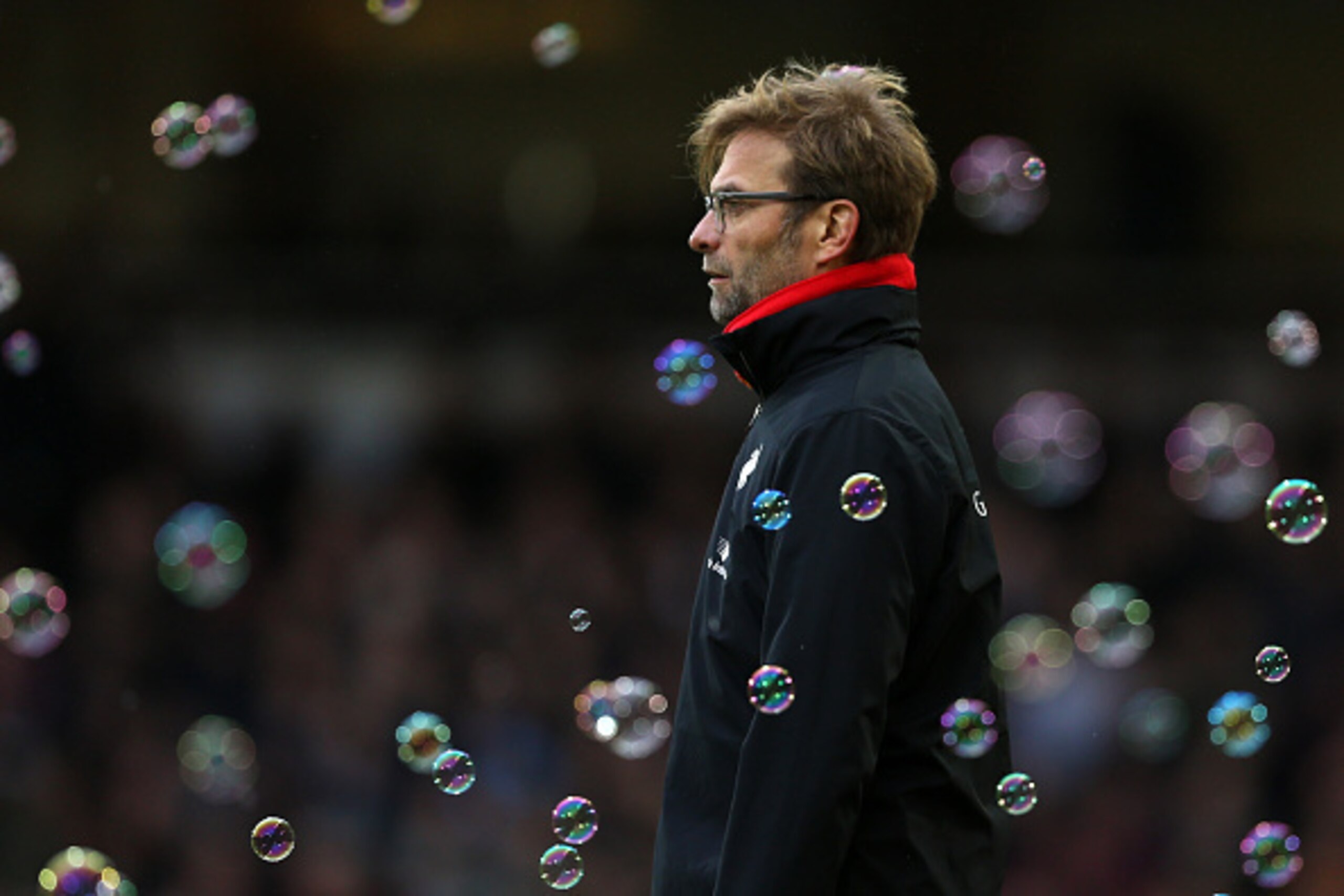 Liverpool's German manager Jurgen Klopp watches through the bubbles during the English Premier League football match between West Ham United and Liverpool at The Boleyn Ground in Upton Park, East London on January 2, 2016. West Ham won the game 2-0. AFP P