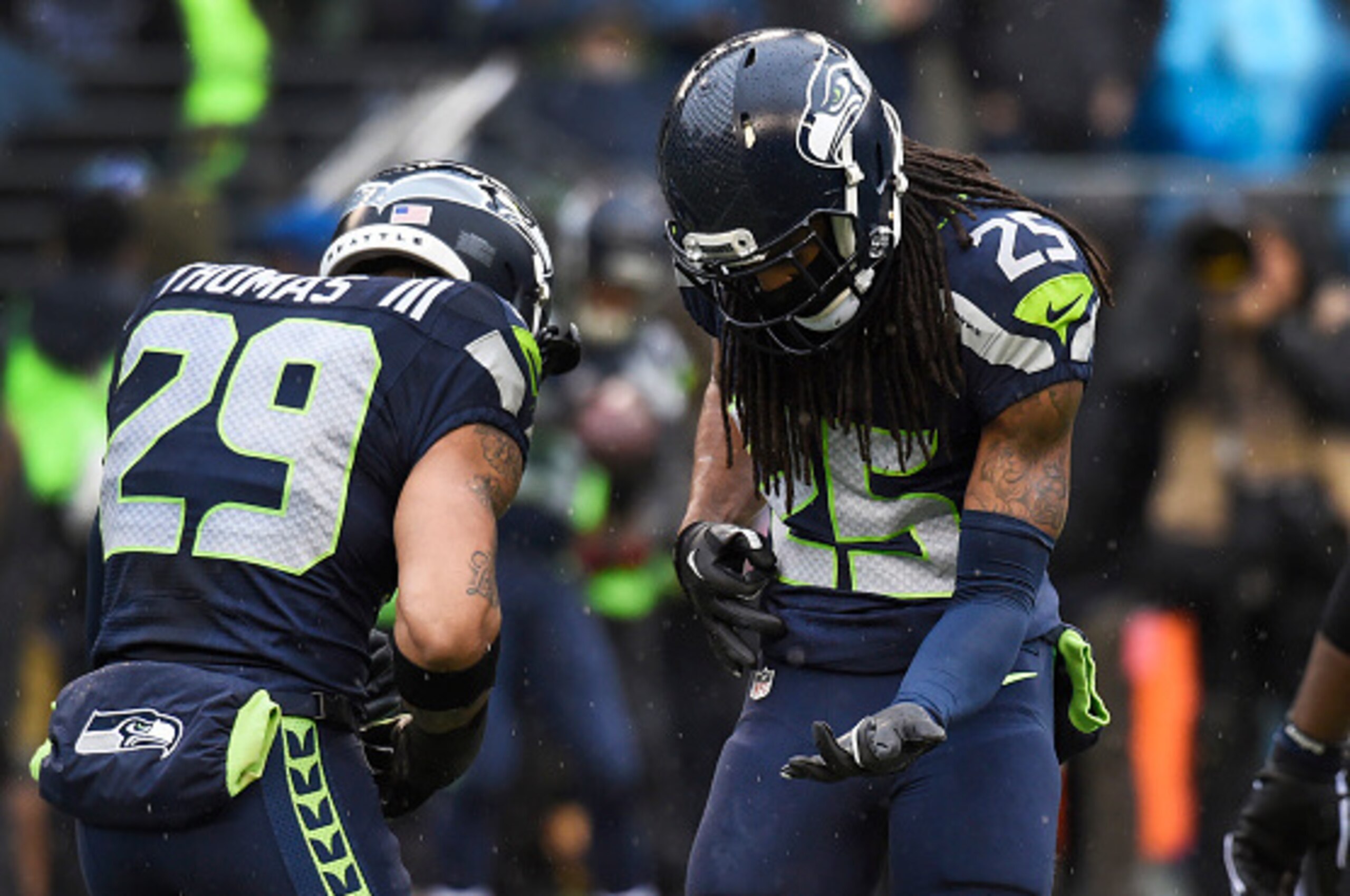 SEATTLE, WA - DECEMBER 27: Free safety Earl Thomas #29 and cornerback Richard Sherman #25 of the Seattle Seahawks play a little air guitar before the game against the St. Louis Rams at CenturyLink Field on December 27, 2015 in Seattle,Washington. (Photo b