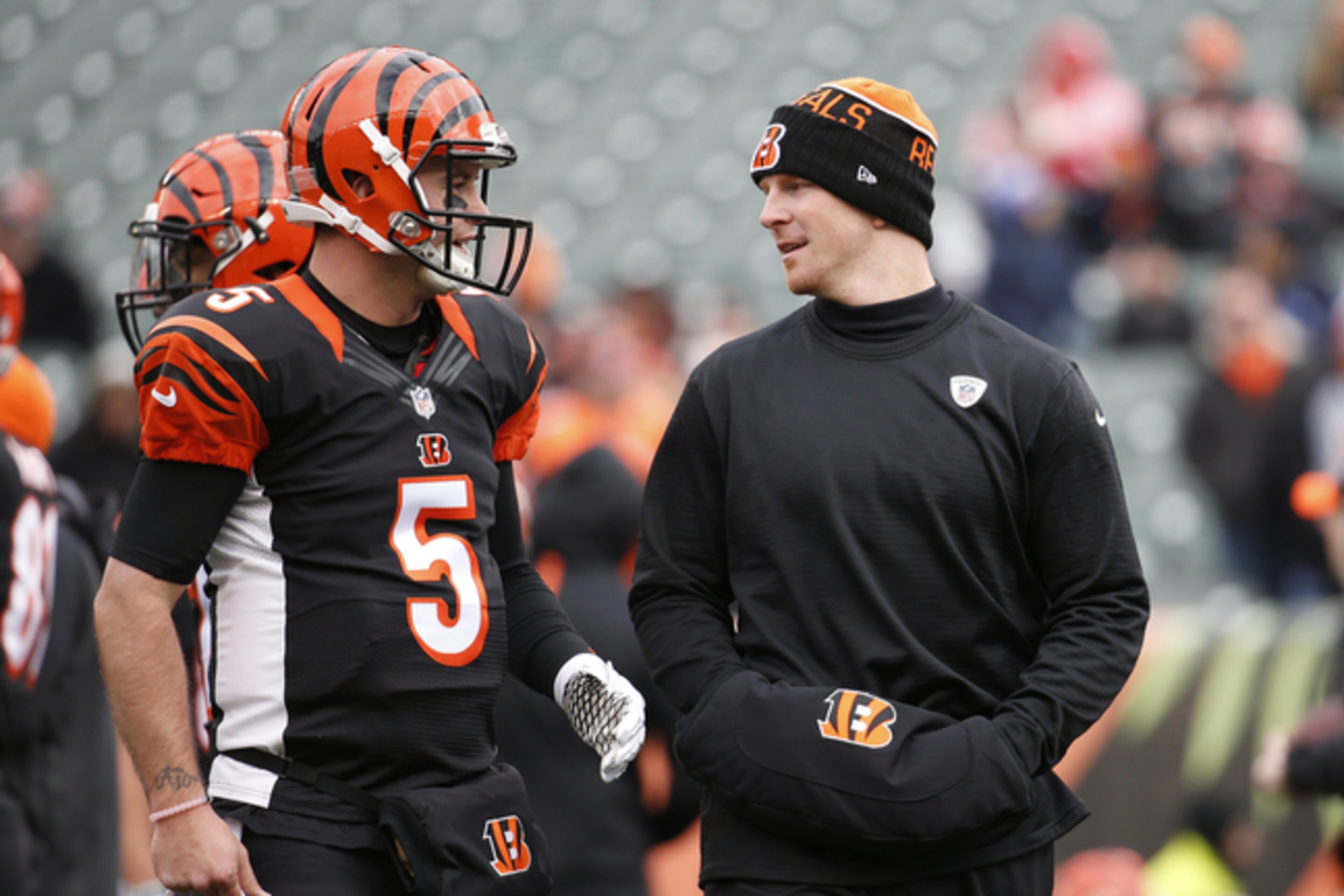 Andy Dalton (right) will most likely miss the Bengals' first playoff game with AJ McCarron (left) filling in.