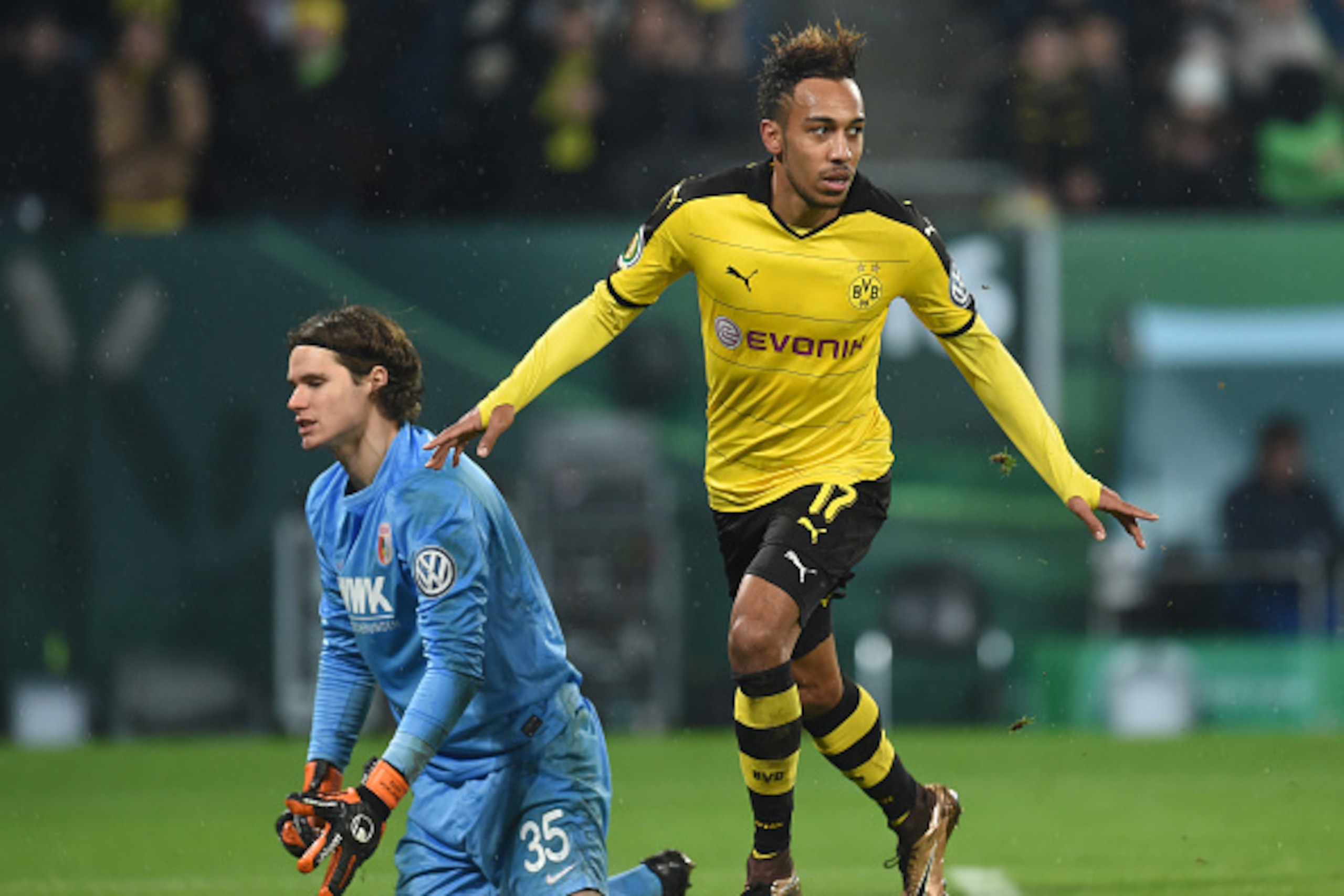 Dortmund's Gabonese striker Pierre-Emerick Aubameyang (R) celebrates after his goal beside Augsburg's Swiss goalkeeper Marwin Hitz (L) during the German Cup DFB Pokal third round match between Borussia Dortmund and FC Augsburg in Augsburg on December 16, 