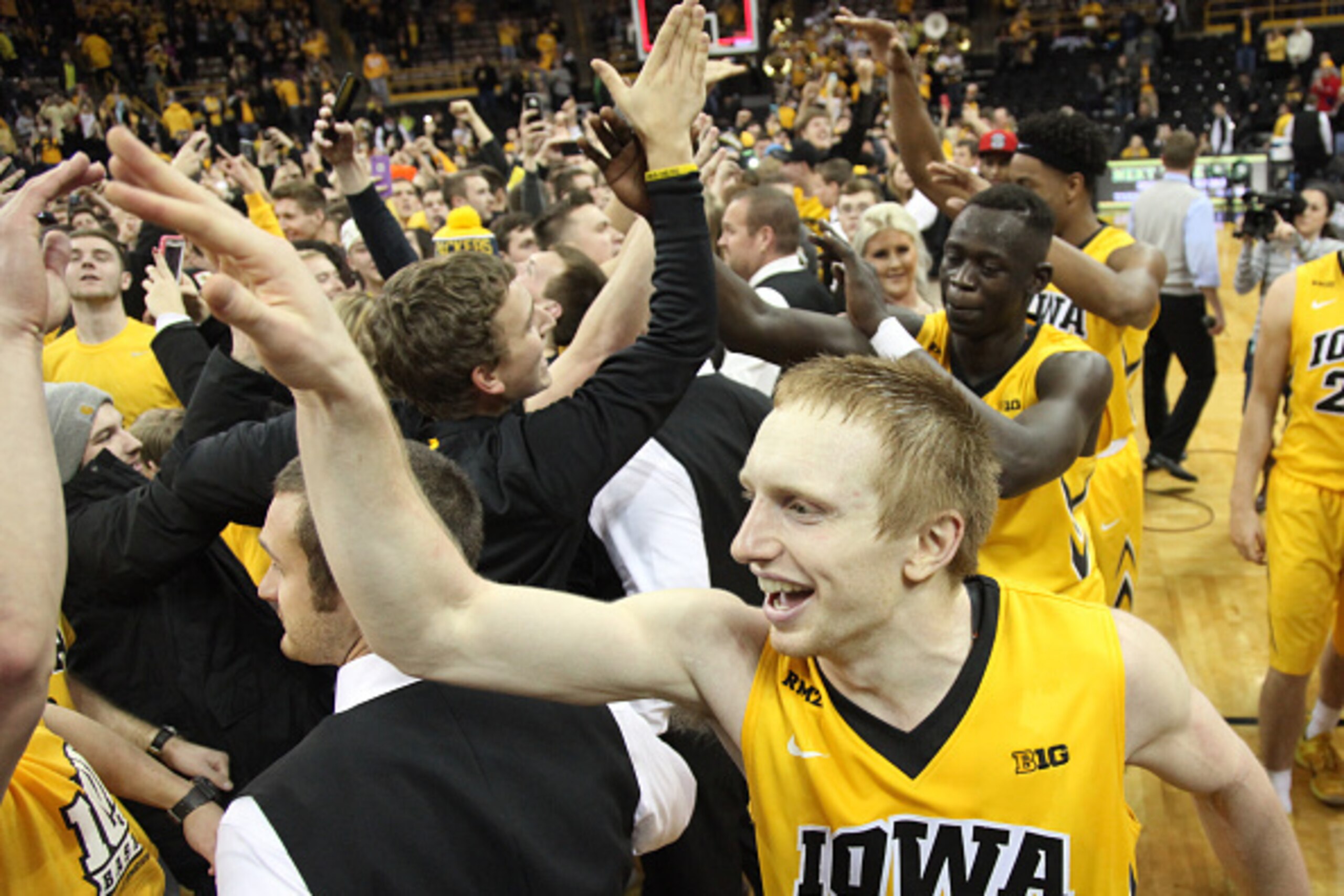 IOWA CITY, IA - DECEMBER 29:  Guard Mike Gesell #10 of the Iowa Hawkeyes celebrates with fans who stormed the court after defeating the Michigan State Spartans on December 29, 2015 at Carver-Hawkeye Arena, in Iowa City, Iowa.  (Photo by Matthew Holst/Gett