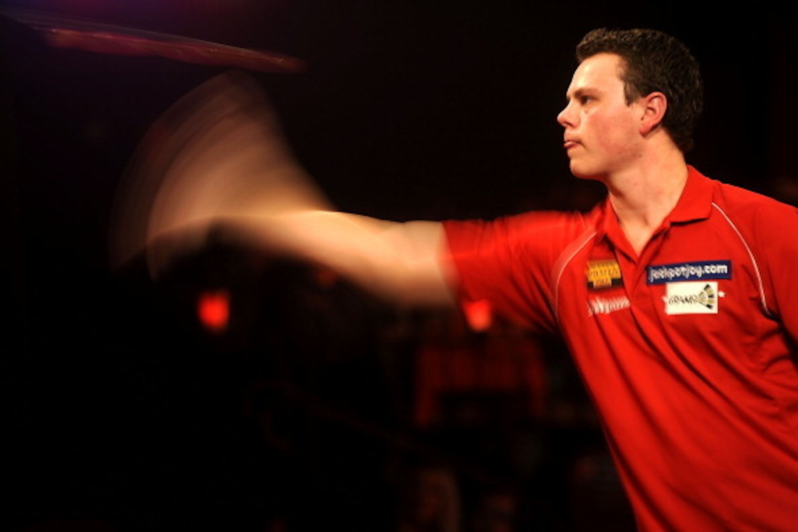 FRIMLEY, ENGLAND - JANUARY 04: Jeffrey de Graaf of Netherlands in action against Martin Atkins of England on day one of the BDO Lakeside World Professional Darts Championships at  Lakeside Complex on January 4, 2014 in Frimley, England. (Photo by Tom Dula