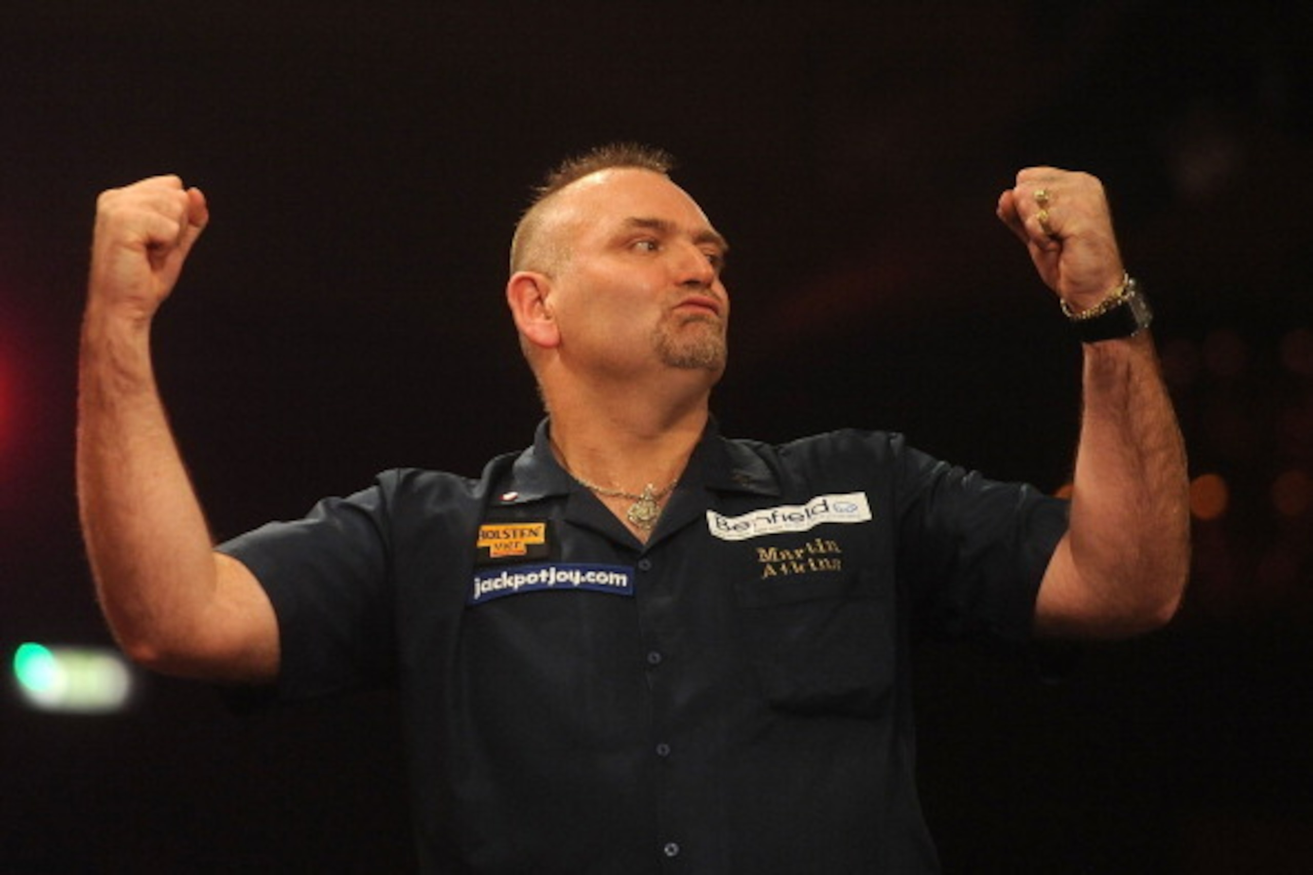 FRIMLEY, ENGLAND - JANUARY 04: Martin Atkins of England celebrates his win on day one of the BDO Lakeside World Professional Darts Championships at  Lakeside Complex on January 4, 2014 in Frimley, England. (Photo by Tom Dulat/Getty Images)