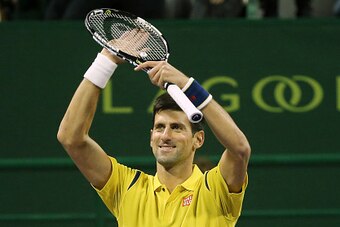 Novak Djokovic of Serbia celebrates winning his tennis match against Dustin Brown of Germany in the Qatar Open competition on January 4, 2016, in Doha. Djokovic won the match 6-2, 6-2. AFP PHOTO / KARIM JAAFAR / AFP / KARIM JAAFAR        (Photo credit sho
