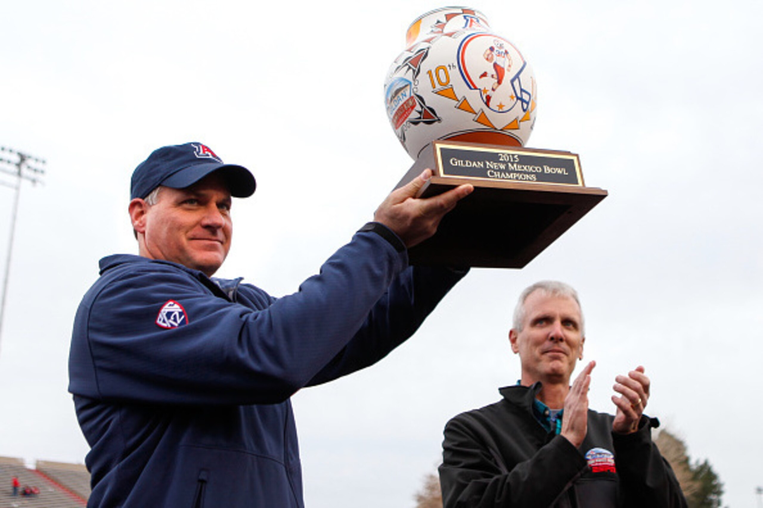 ALBUQUERQUE, NM - DECEMBER 19: Head Coach Rich Rodriguez of the Arizona Wildcats holds up the Gildan Bowl Trophy at University Stadium on December 19, 2015 in Albuquerque, New Mexico. Arizona won 45-37. (Photo by Aaron Sweet/Getty Images) ALBUQUERQUE, NM - DECEMBER 19: Head Coach Rich Rodriguez of the Arizona Wildcats holds up the Gildan Bowl Trophy at University Stadium on December 19, 2015 in Albuquerque, New Mexico. Arizona won 45-37. (Photo by Aaron Sweet/Getty Images)