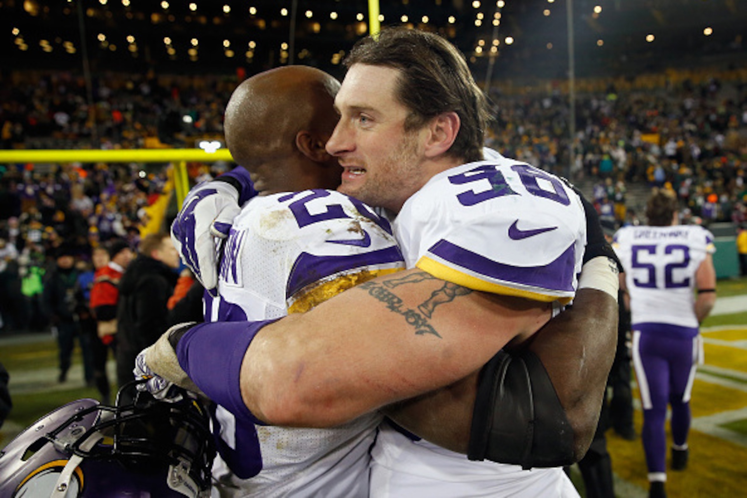 GREEN BAY, WI - JANUARY 03:  Adrian Peterson #28 of the Minnesota Vikings celebrates with Brian Robison #96 after defeating the Green Bay Packers with a score of 20 to 13 at Lambeau Field on January 3, 2016 in Green Bay, Wisconsin.  (Photo by Jon Durr/Get
