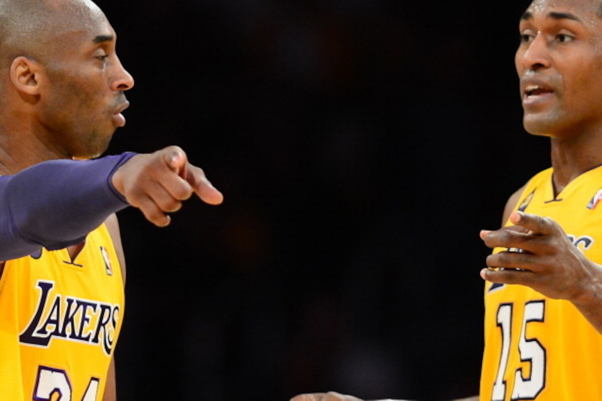 Kobe Bryant  (L) of the Los Angeles Lakers speaks on court with teammate Metta World Peace (R) during their NBA game against the Washington Wizards on March 22, 2013 in Los Angeles. It is the first return to the court by Bryant and teammate Pau Gasol foll