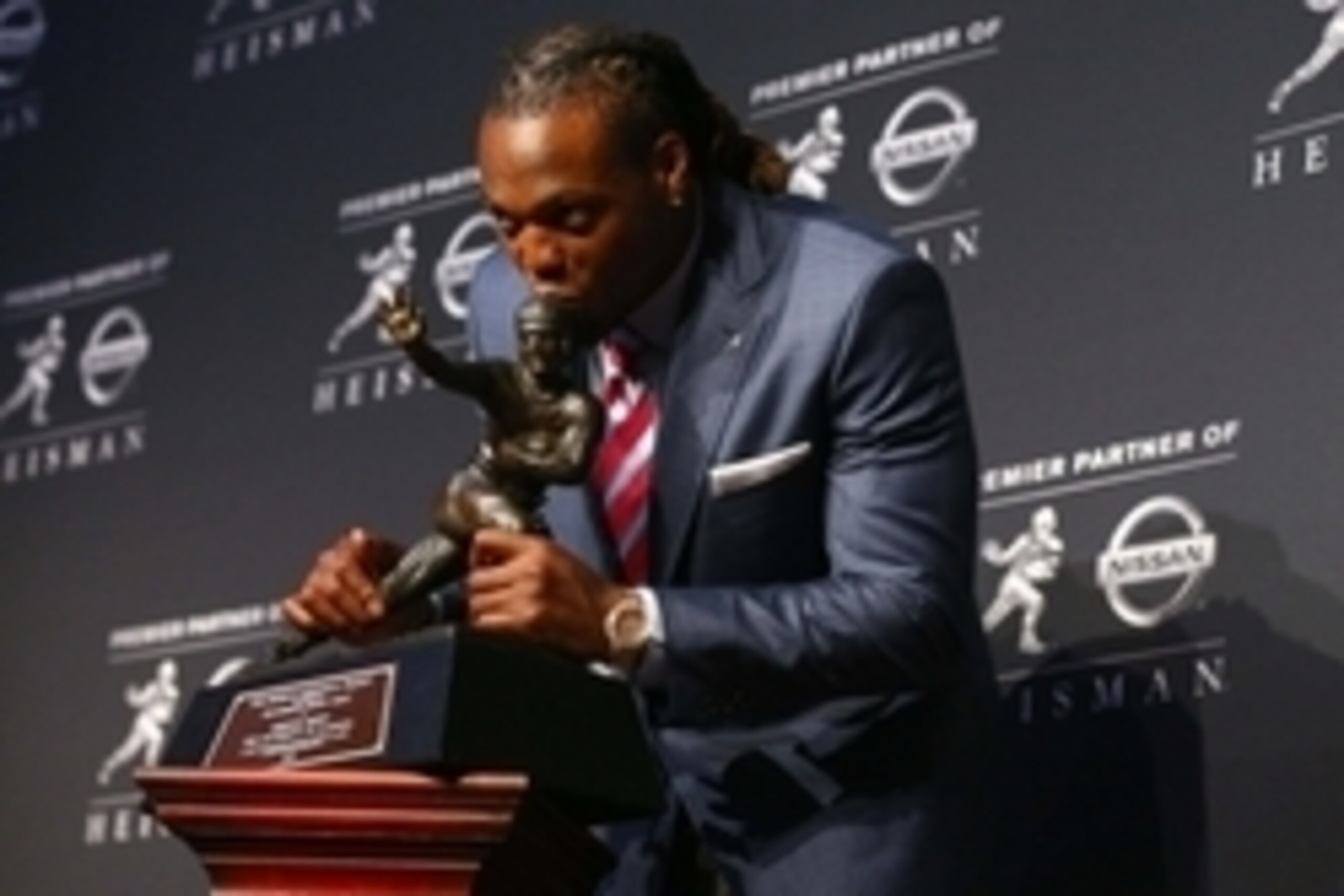 Dec 12, 2015; New York, NY, USA; Alabama running back Derrick Henry kisses the Heisman Trophy during a press conference at the New York Marriott Marquis after winning the trophy during the 81st annual Heisman Trophy presentation. Mandatory Credit: Brad Pe