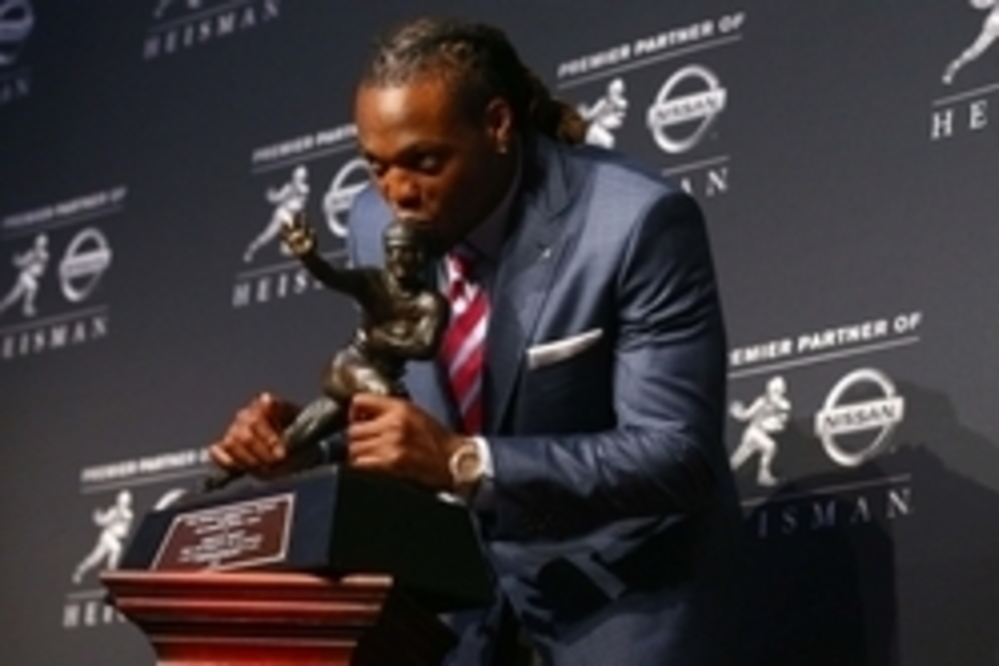 Dec 12, 2015; New York, NY, USA; Alabama running back Derrick Henry kisses the Heisman Trophy during a press conference at the New York Marriott Marquis after winning the trophy during the 81st annual Heisman Trophy presentation. Mandatory Credit: Brad Pe