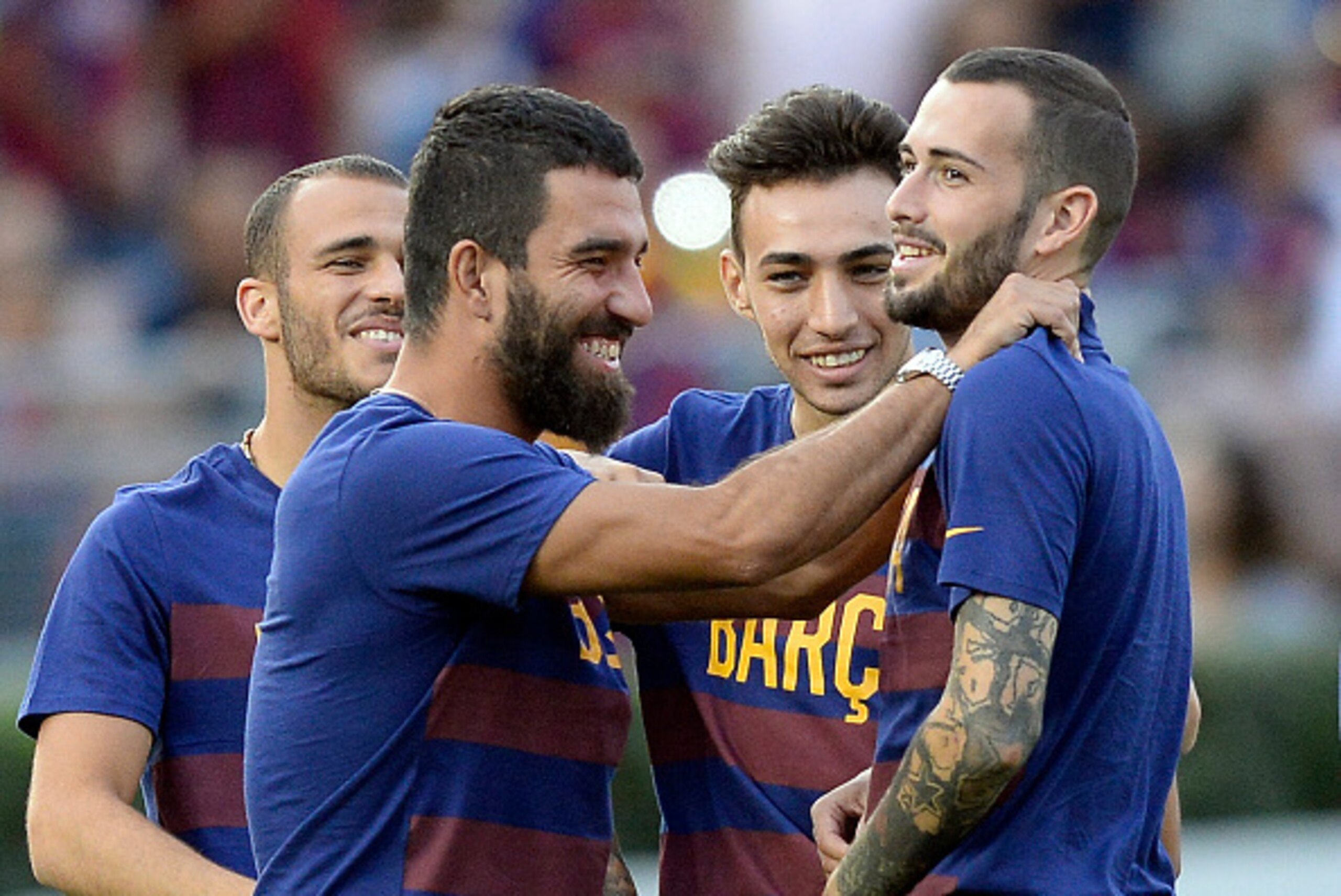 PASADENA, CA - JULY 21: Newly signed midfielder Arda Turan (L) of FC Barcelona hugs teammate Aleix Vidal (R) as Munir El Haddadi #17 and Sandro Ramirez #19 look on during team warm up prior to start of their friendly soccer match against Los Angeles Galax PASADENA, CA - JULY 21: Newly signed midfielder Arda Turan (L) of FC Barcelona hugs teammate Aleix Vidal (R) as Munir El Haddadi #17 and Sandro Ramirez #19 look on during team warm up prior to start of their friendly soccer match against Los Angeles Galax