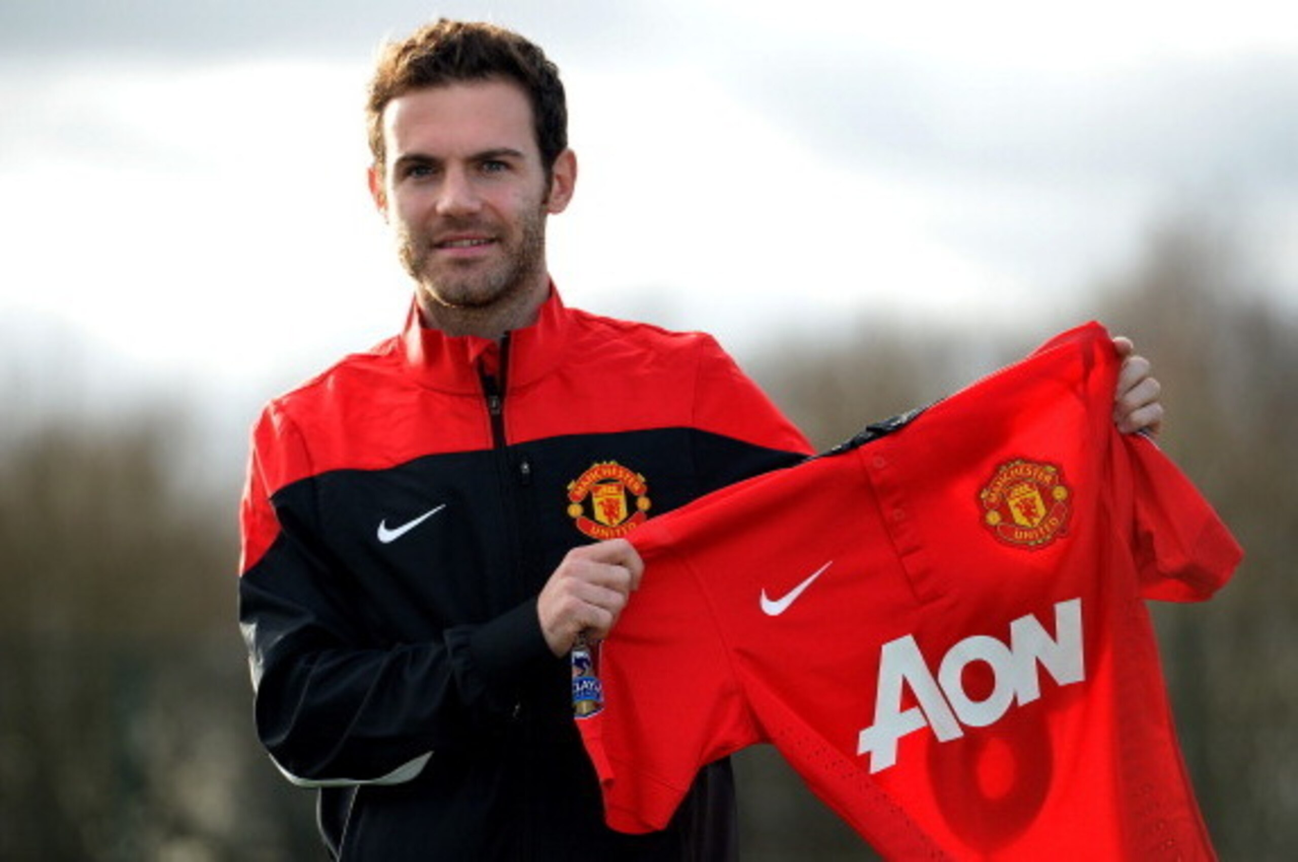 Manchester United's new signing Spanish midfielder Juan Mata poses for photographers at the club training ground in Manchester, north west England, on January 27, 2014. Manchester United manager David Moyes said on January 26 that the club-record acquisit
