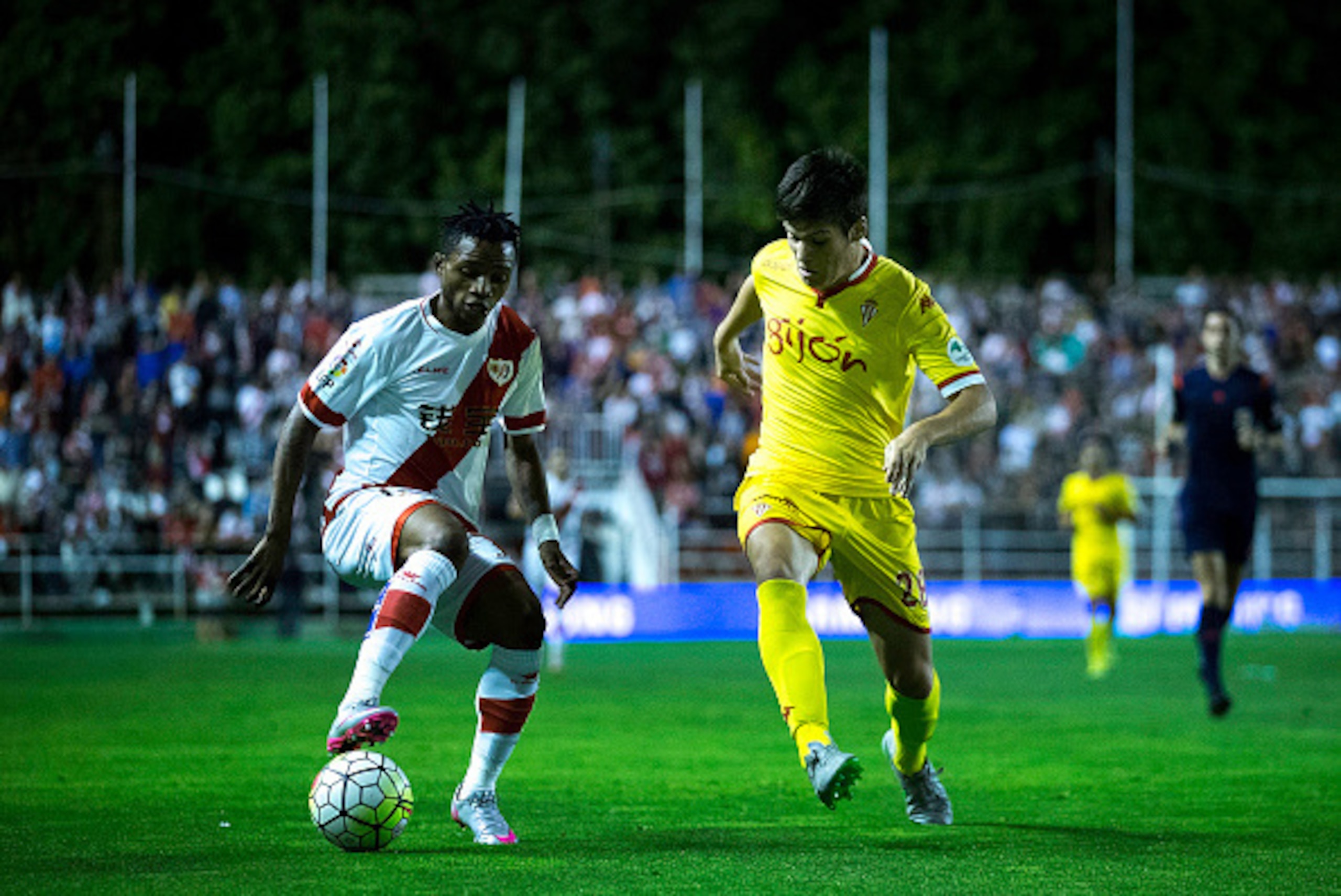 MADRID, SPAIN - SEPTEMBER 23: Lassane Bangoura alias Lass B. (L) of Rayo Vallecano de Madrid competes for the ball with Jorge Mere (R) of Real Sporting de Gijon during the La Liga match between Rayo Vallecano de Madrid and Real Sporting de Gijon at Estadi