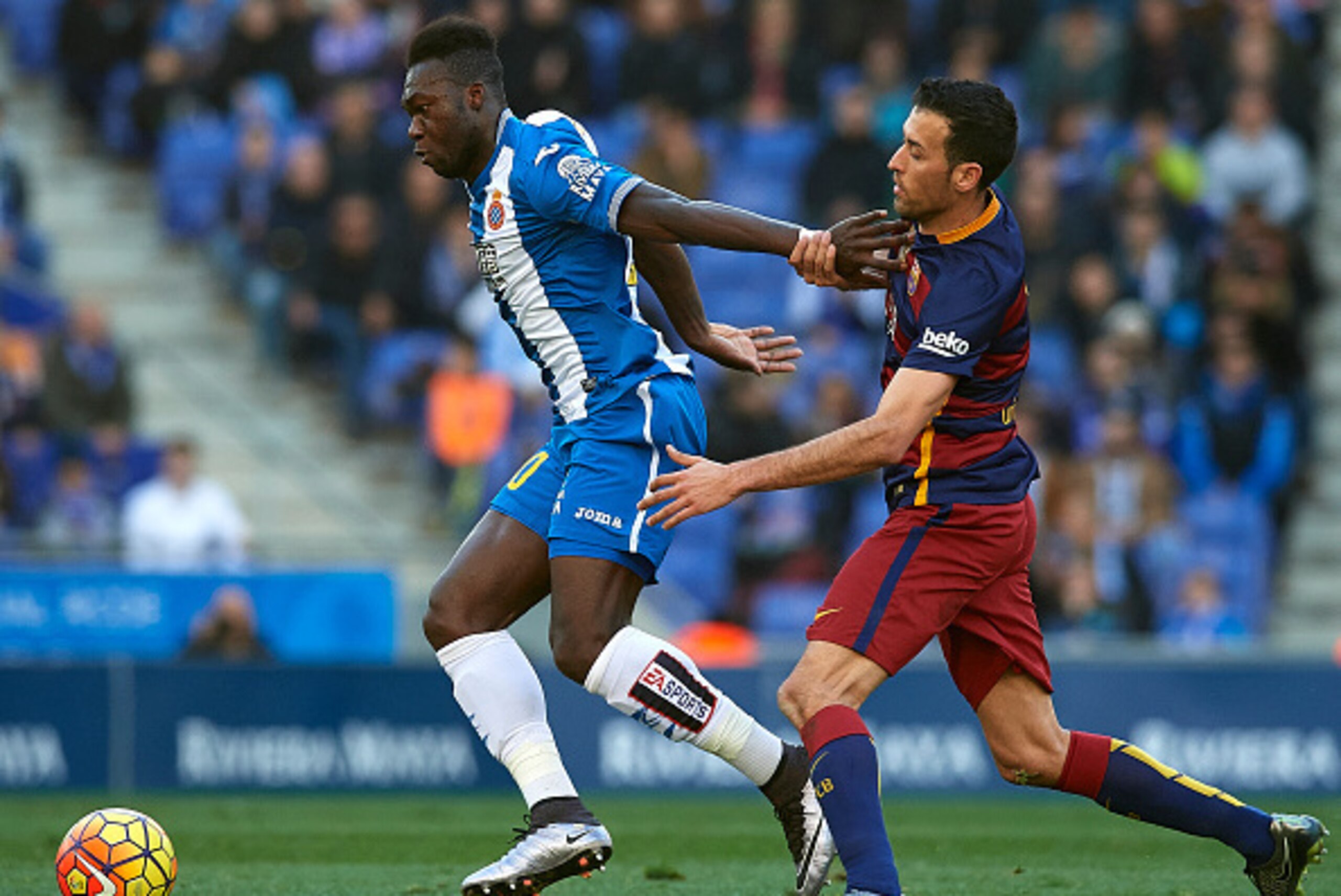 BARCELONA, SPAIN - JANUARY 02:  Joan Felipe Caicedo of Espanyol is tackled by  Sergio Busquets of Barcelona during the La Liga match between Real CD Espanyol and FC Barcelona at Cornella-El Prat Stadium on January 2, 2016 in Barcelona, Spain.  (Photo by M