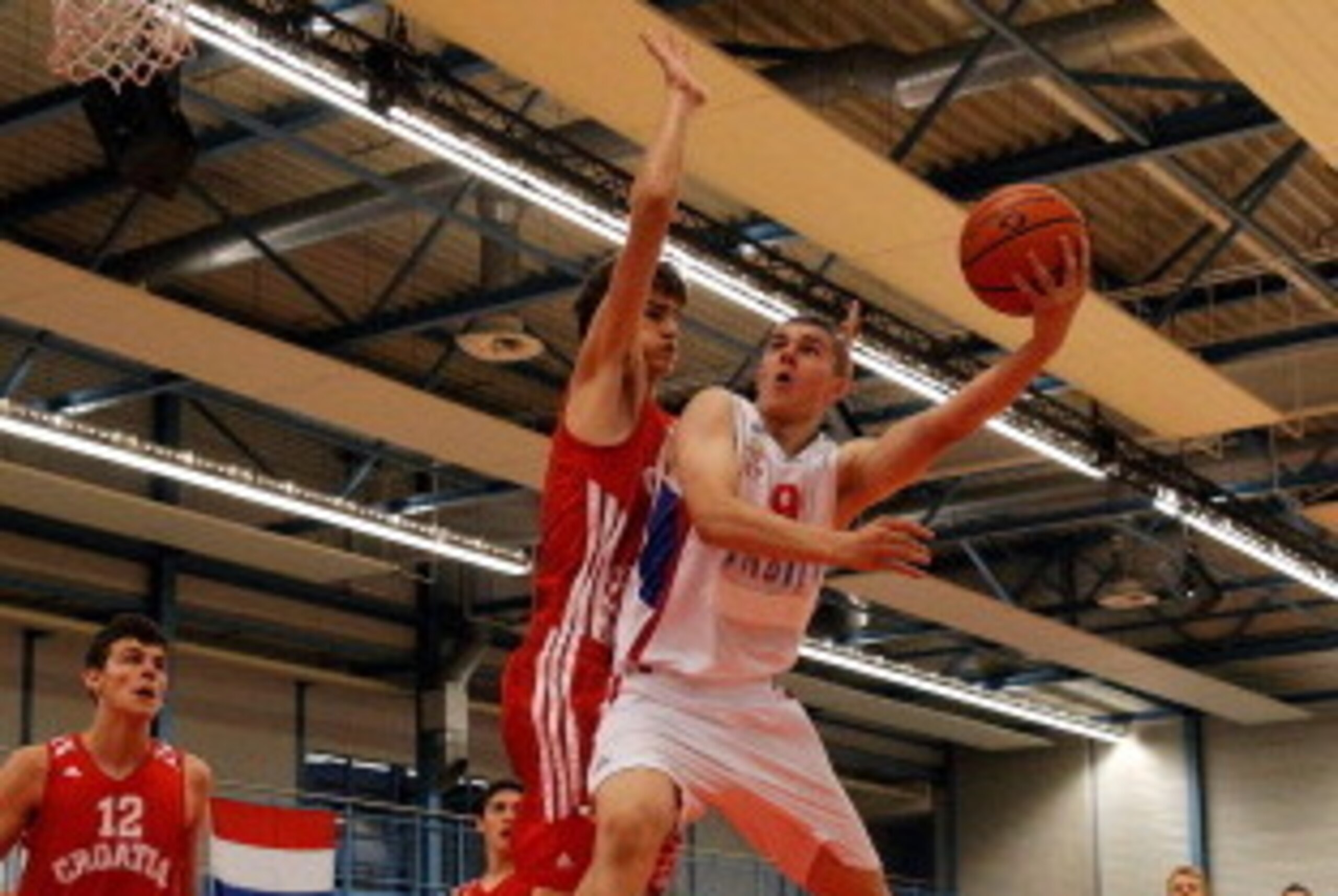 UTRECHT, NETHERLANDS - JULY 17:  Dragan Bender (red) of Croatia attempts to stop Vojislav Stojanovic of Serbia attack in the Boys Basketball match between Croatia and Serbia on Day 3 of the European Youth Olympic Festival held at De Uithof Olympos Sports 