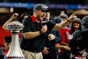 ATLANTA, GA - DECEMBER 31:  Head coach Tom Herman of the Houston Cougars celebrates alongside the trophy after their 38-24 win over the Florida State Seminoles during the Chick-fil-A Peach Bowl at the Georgia Dome on December 31, 2015 in Atlanta, Georgia.
