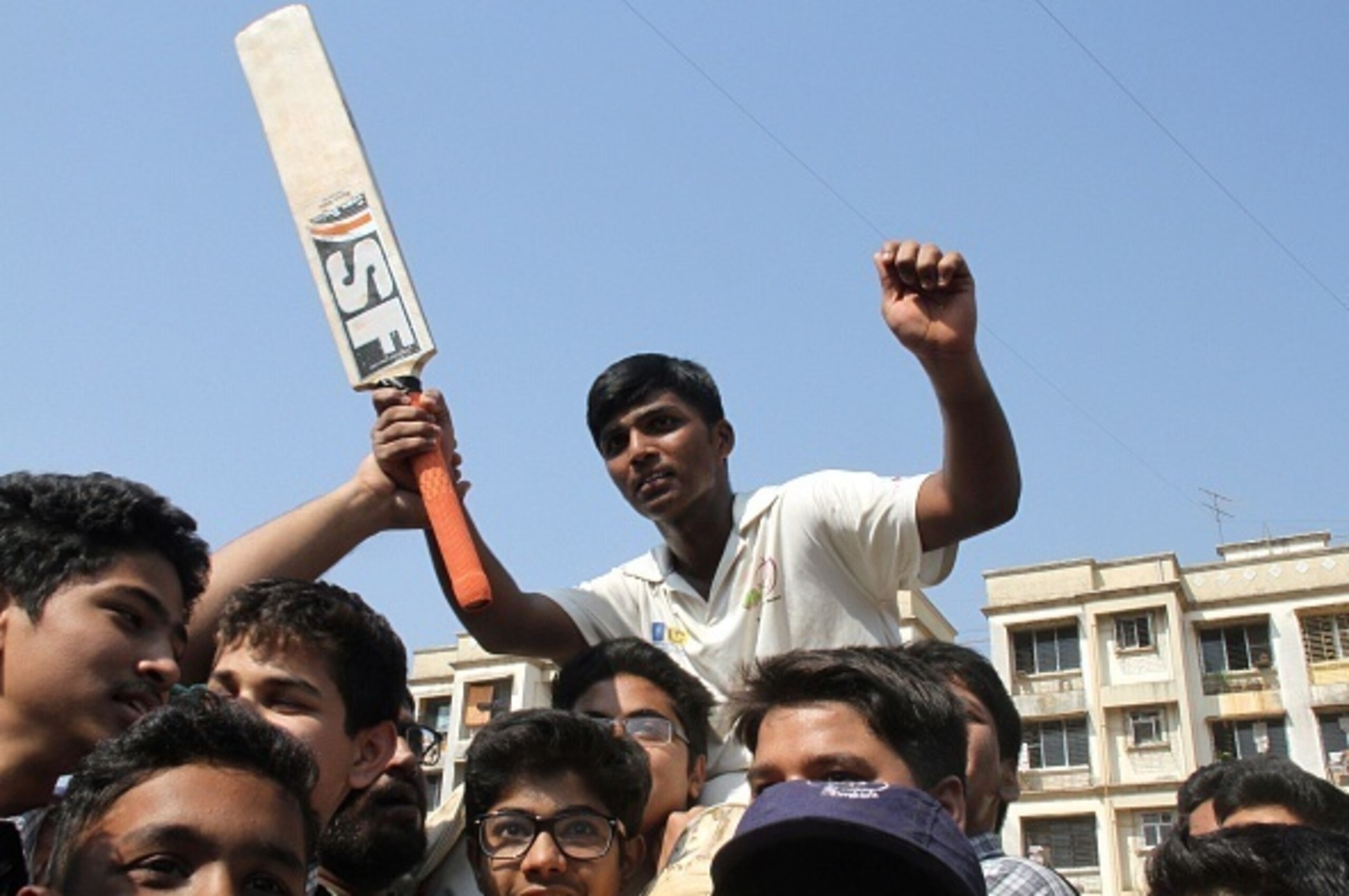 Mumbai schoolboy Pranav Dhanawade (C), 15, is carried as he celebrates smashing a 117-year-old record for the highest number of runs scored in one innings in Mumbai on January 5, 2016. A Mumbai schoolboy made history on January 5 when he became the first 
