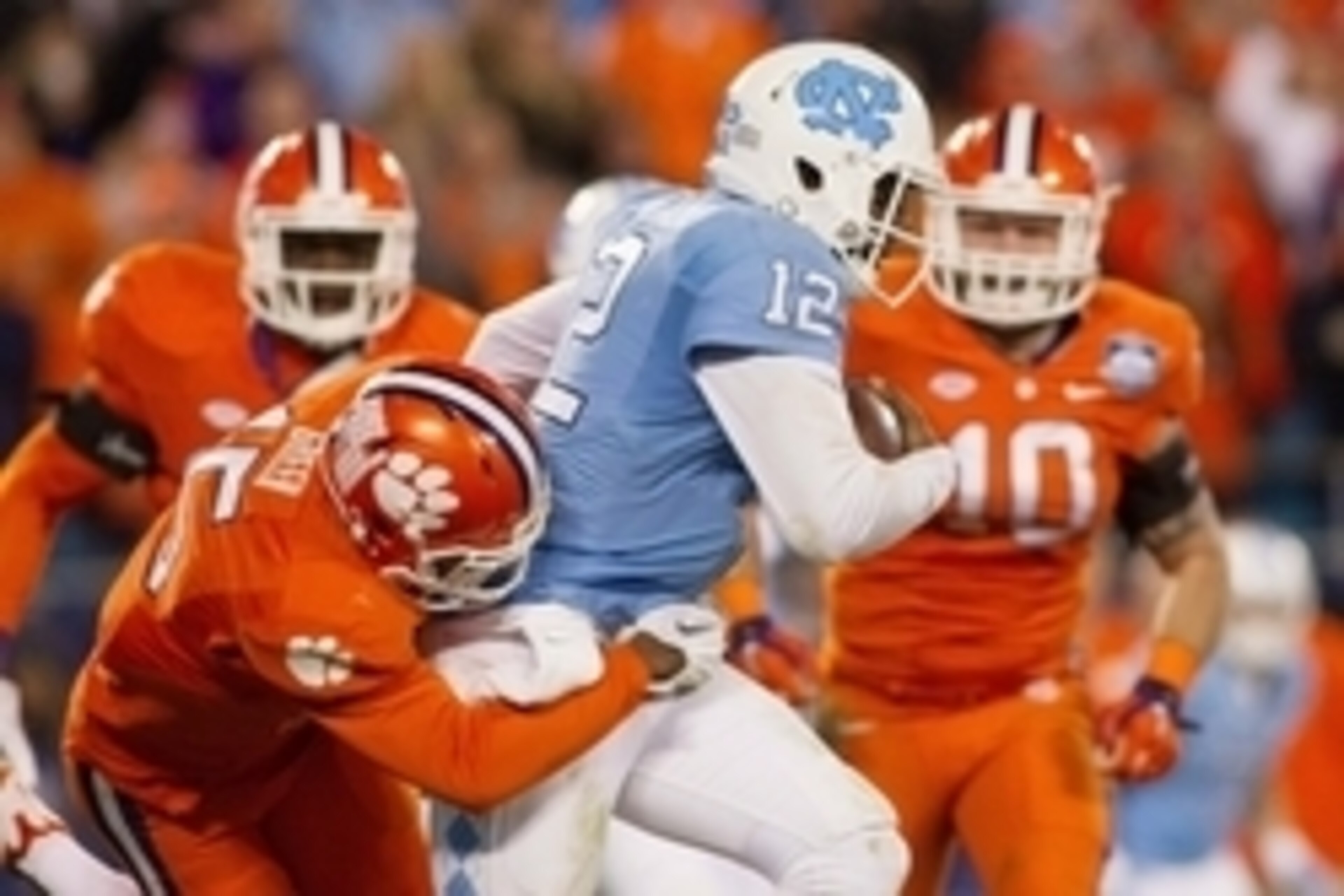 Dec 5, 2015; Charlotte, NC, USA; North Carolina Tar Heels quarterback Marquise Williams (12) is sacked by Clemson Tigers safety T.J. Green (15) during the second quarter in the ACC football championship game at Bank of America Stadium. Mandatory Credit: J