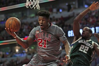 CHICAGO, IL - JANUARY 05: Jimmy Butler #21 of the Chicago Bulls falls to the floor after being fouled by Khris Middleton #22 of the Milwaukee Bucks at the United Center on January 5, 2016 in Chicago, Illinois. The Bulls defeated the Bucks 117-106. NOTE TO