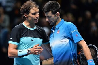 Serbia's Novak Djokovic (R) greets Spain's Rafael Nadal after winning the men's singles semi-final match on day seven of the ATP World Tour Finals tennis tournament in London on November 21, 2015. Djokovic won 6-3, 6-3. 
AFP PHOTO / GLYN KIRK        (Phot