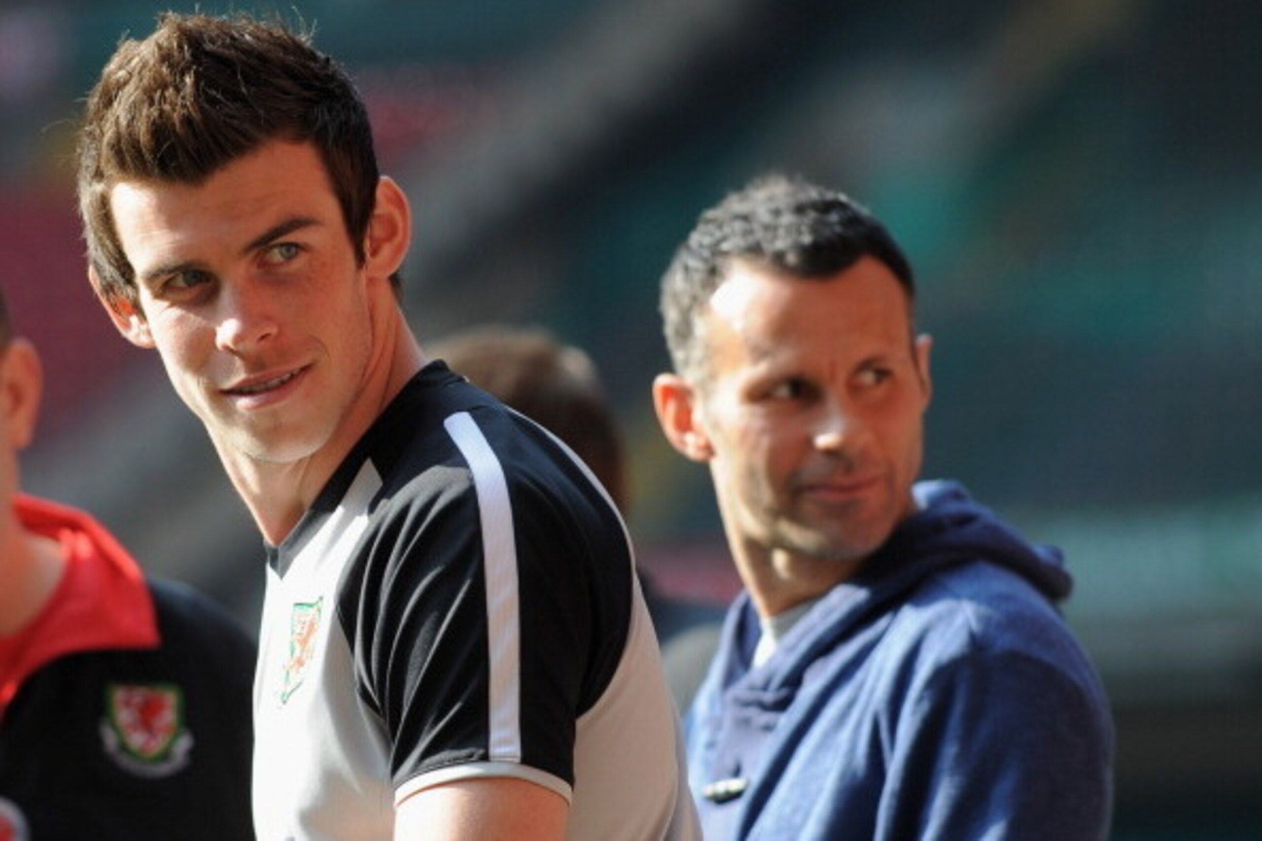 CARDIFF, WALES - MARCH 25:  Gareth Bale looks on as he sits out with an injury with Ryan Giggs during the Wales training session ahead of their UEFA EURO 2012 qualifier against England on March 25, 2011 in Cardiff, Wales.  (Photo by Michael Regan/Getty Im