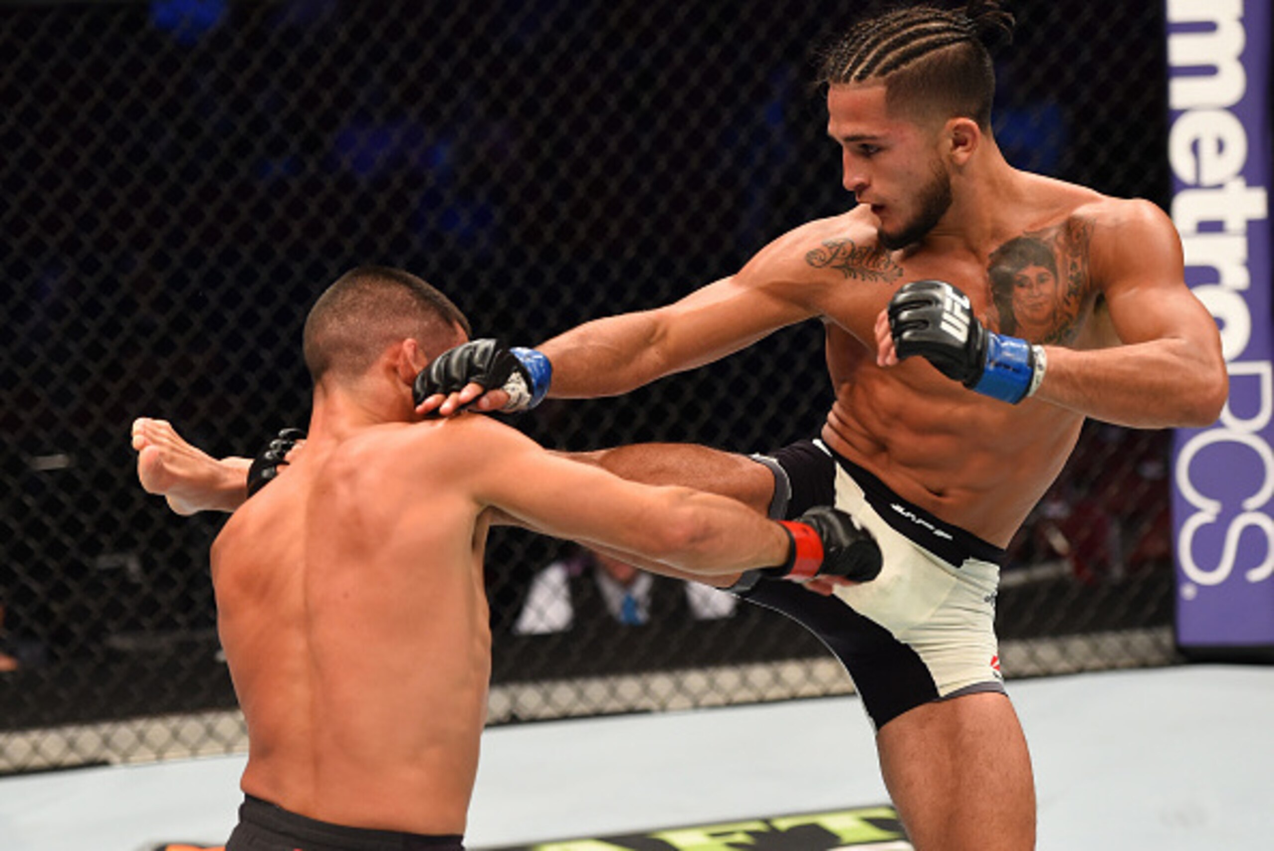 HOUSTON, TX - OCTOBER 03:  (R-L) Sergio Pettis kicks Chris Cariaso in their flyweight bout during the UFC 192 event at the Toyota Center on October 3, 2015 in Houston, Texas. (Photo by Josh Hedges/Zuffa LLC/Zuffa LLC via Getty Images)