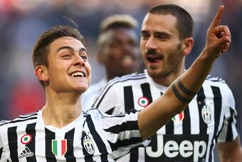 Juventus' forward Paulo Dybala from Argentina (L) celebrates after scoring  with Juventus' defender Leonardo Bonucci during the Italian Serie A  football match Juventus Vs Hellas Verona on January 6, 2016 at the 'Juventus Stadium' in Turin.  AFP PHOTO / M