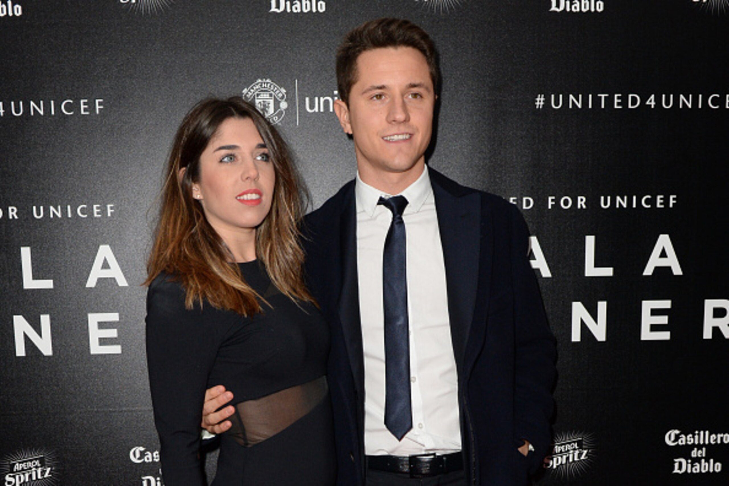 Manchester United's Spanish midfielder Ander Herrera (R) and his girlfriend Isabel Collado pose for pictures on the red carpet as they arrive to attend the 'United for UNICEF Gala Dinner' at Old Trafford in Manchester, north-west England, on November 29, 