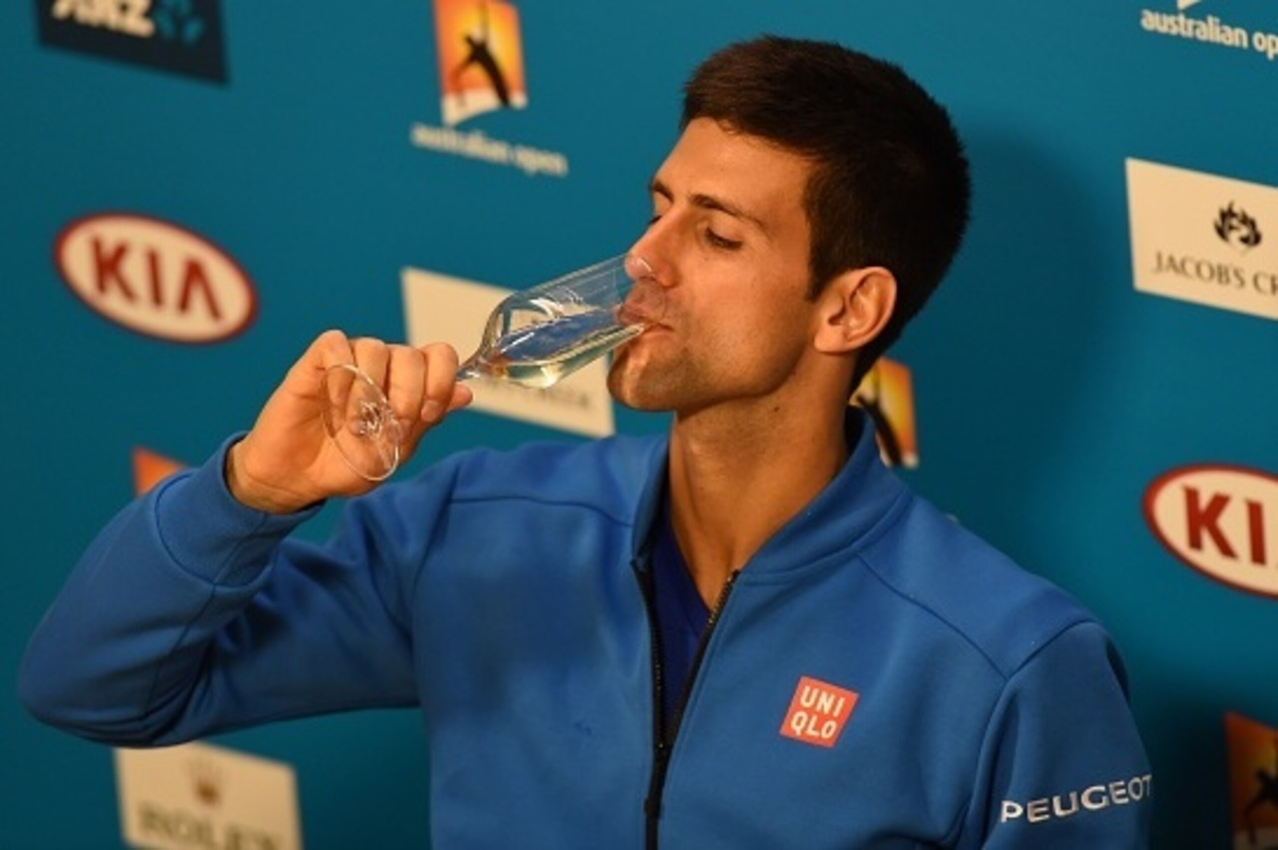 Serbia's Novak Djokovic drinks a glass of champagne as he addresses a press conference after victory in his men's singles final match against Britain's Andy Murray on day fourteen of the 2015 Australian Open tennis tournament in Melbourne early  February 