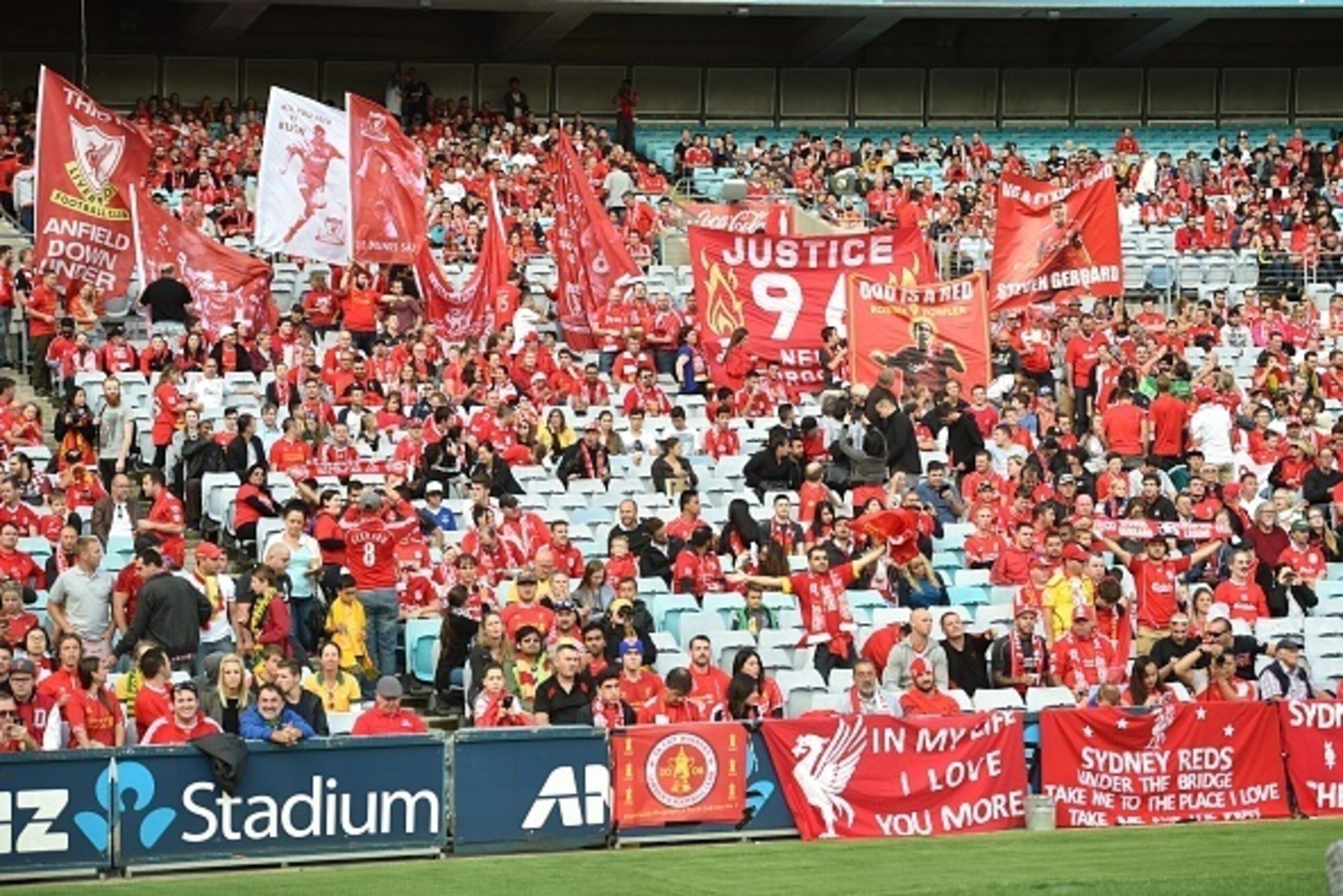 Liverpool fans hold up banners before the start of Liverpool Legends exhibition football game against Australian Legends at the ANZ Stadium in Sydney on January 7, 2016. AFP PHOTO / Peter PARKS    
IMAGE STRICTLY FOR EDITORIAL USE - STRICTLY NO COMMERCIAL