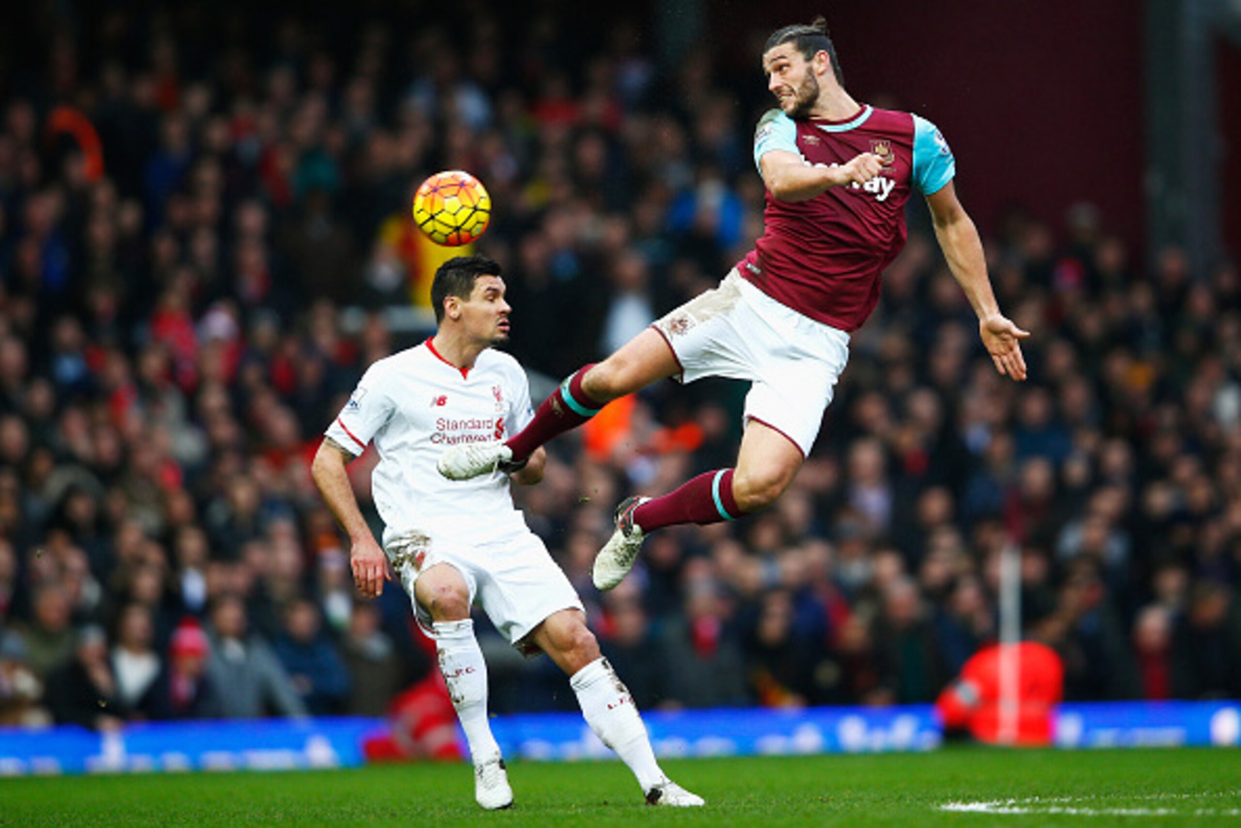 LONDON, ENGLAND - JANUARY 02: Andy Carroll of West Ham United and Dejan Lovren of Liverpool compete for the ball during the Barclays Premier League match between West Ham United and Liverpool at Boleyn Ground on January 2, 2016 in London, England.  (Photo