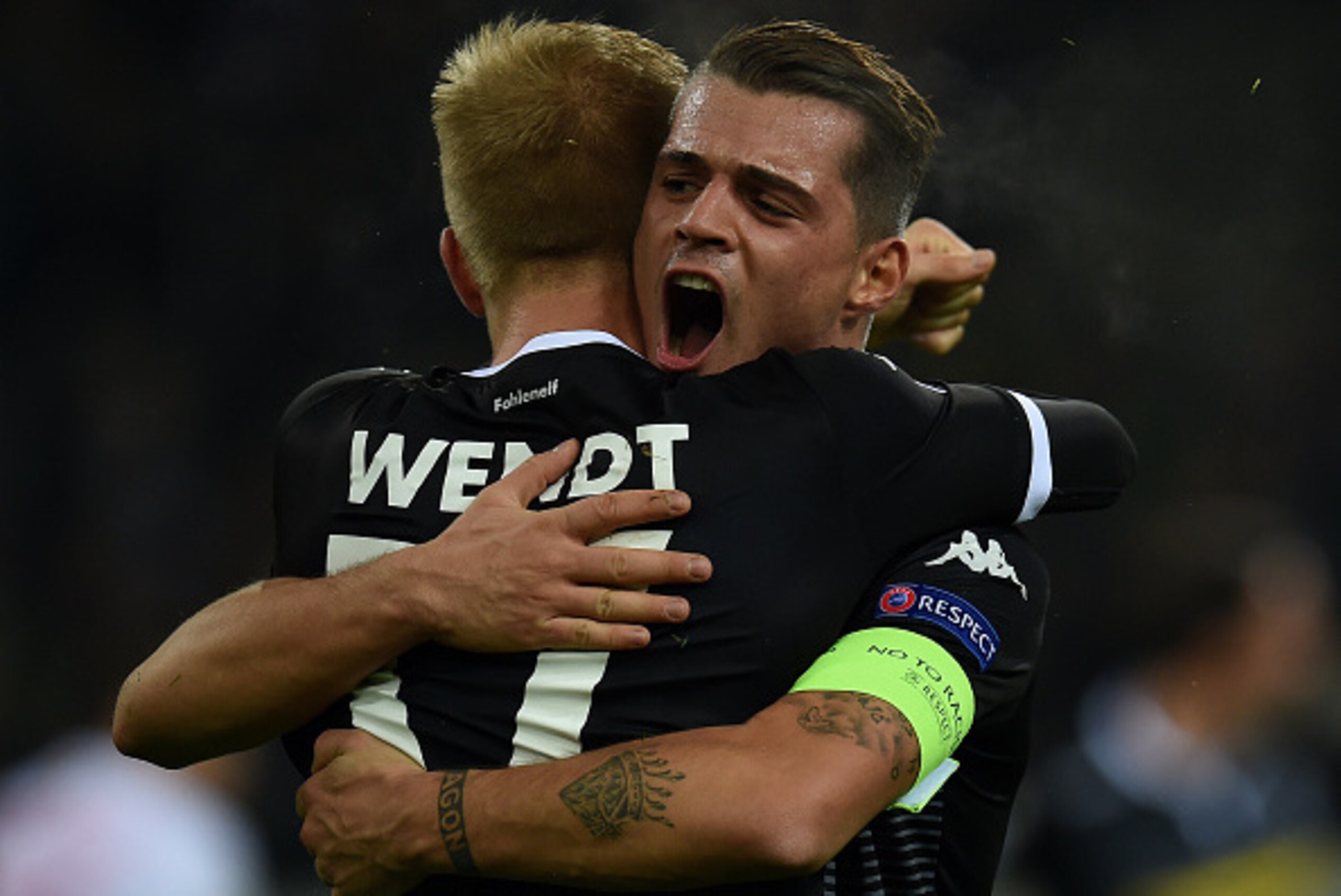 Moenchengladbach's Swedish defender Oscar Wendt and Moenchengladbach's Swiss midfielder Granit Xhaka celebrate 1-0 during the Group D, second-leg UEFA Champions League football match Borussia Moenchengladbach vs FC Sevilla in Moenchengladbach, western Ger
