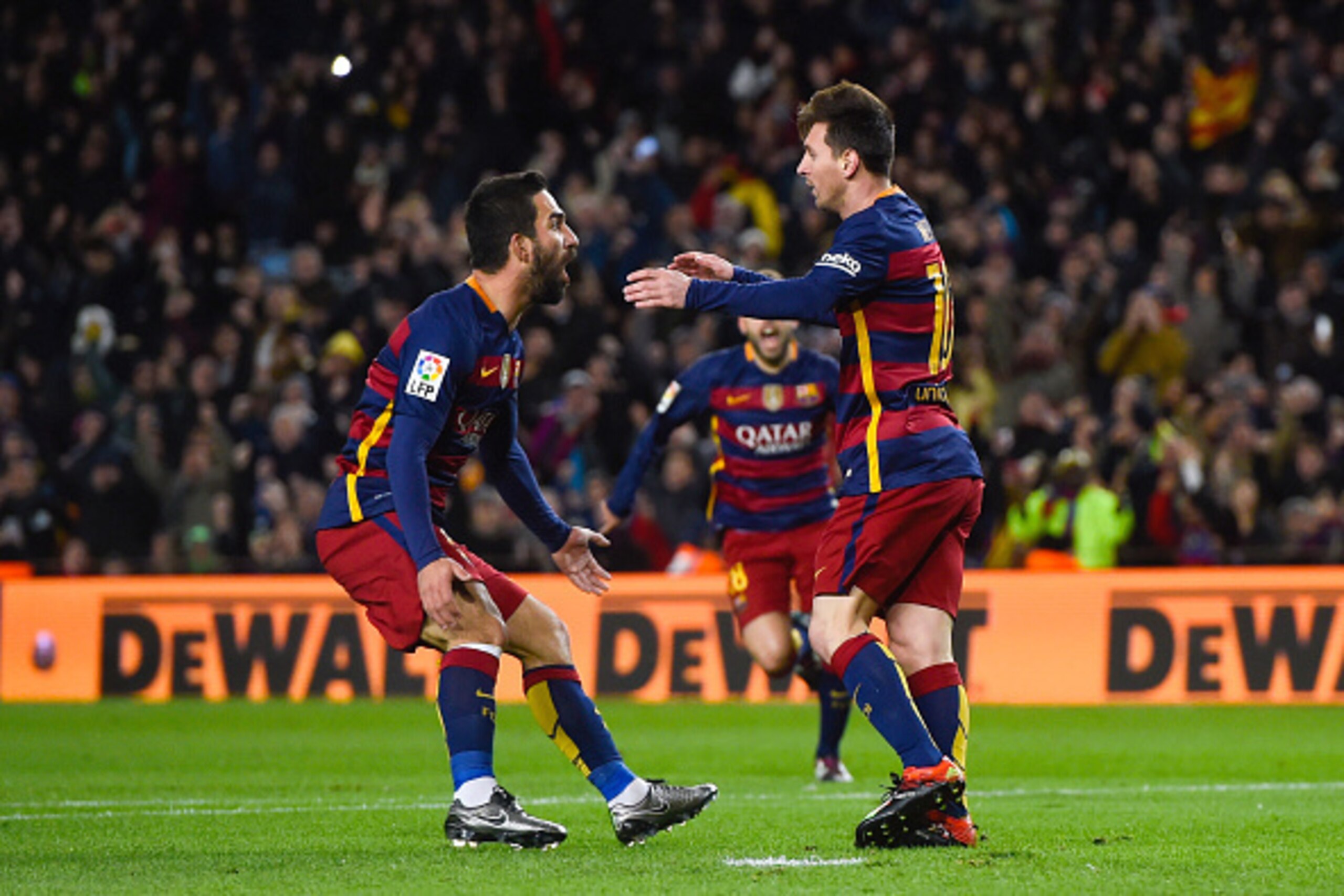 BARCELONA, SPAIN - JANUARY 06:  Lionel Messi of FC Barcelona celebrates with his teammate Arda Turan of FC Barcelona after scoring the opening goal during the Copa del Rey Round of 16 first leg match between FC Barcelona and RCD Espanyol at Camp Nou on Ja