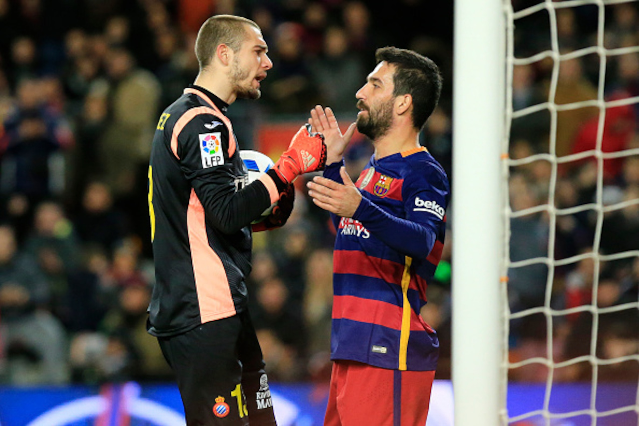 Barcelona's Turkish midfielder Arda Turan (R) argues with RCD Espanyol's Spanish goalkeeper Pau Lopez during the Spanish Copa del Rey (King's Cup) round of 16 first leg football match FC Barcelona vs RCD Espanyol at the Camp Nou stadium in Barcelona on Ja