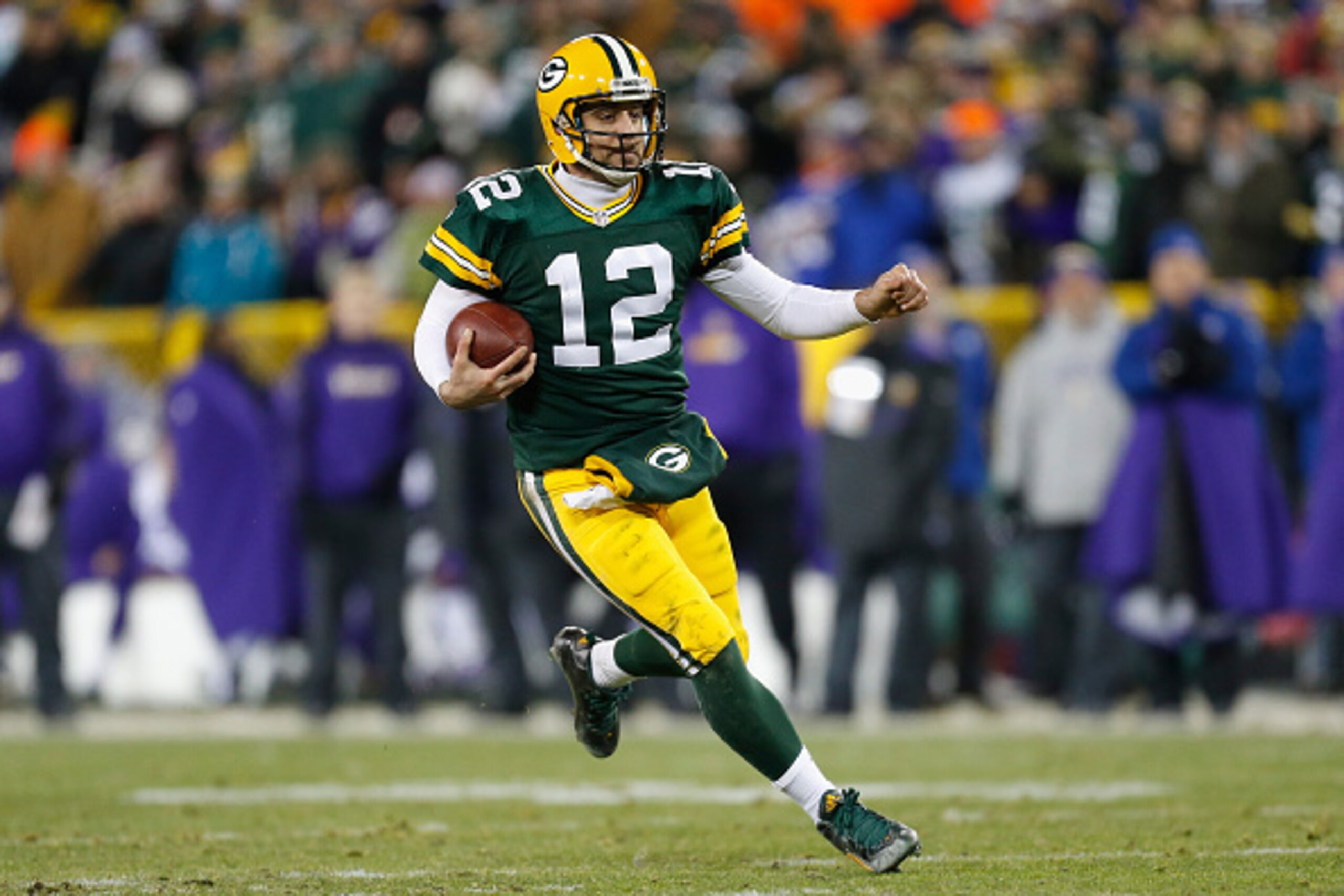 GREEN BAY, WI - JANUARY 03:  Aaron Rodgers #12 of the Green Bay Packers runs with the ball during the second half against the Minnesota Vikings at Lambeau Field on January 3, 2016 in Green Bay, Wisconsin.  (Photo by Wesley Hitt/Getty Images)